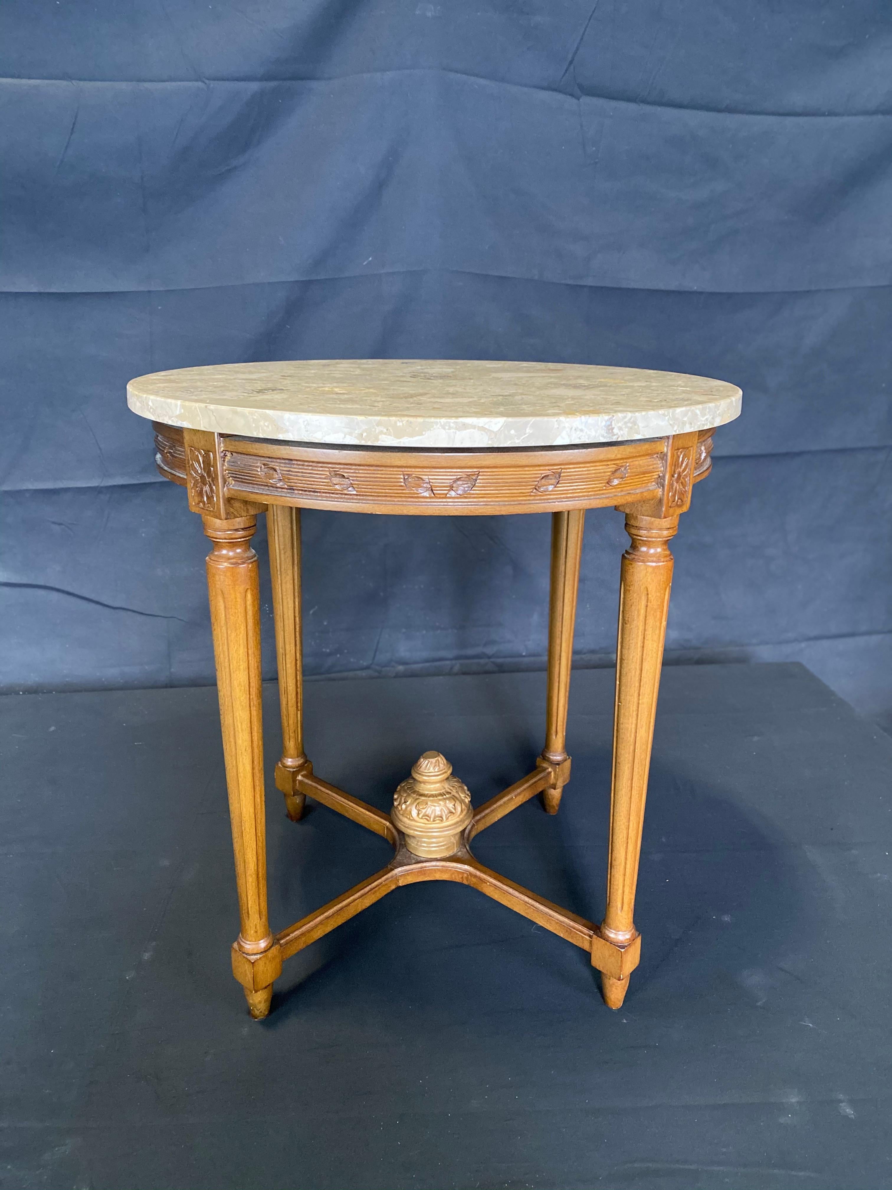 Beautiful walnut French side table or nightstand having a greige (grayish beige) marble top and pretty carvings as well as tapered reeded legs and central finial on the stretchers at the bottom. Great, versatile size!

#5048.