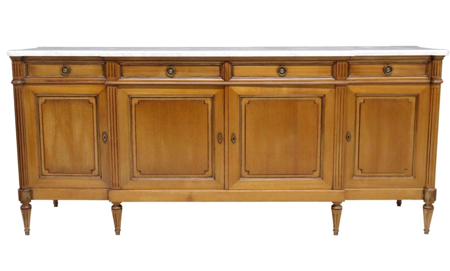 Very impressive French Louis XVI style mahogany enfilade, having white Carrara marble top over four drawers and cabinets leading to interior shelf storage, featuring bronze rosette hardware and trim, rising on tapered legs ending in brass sabots. A
