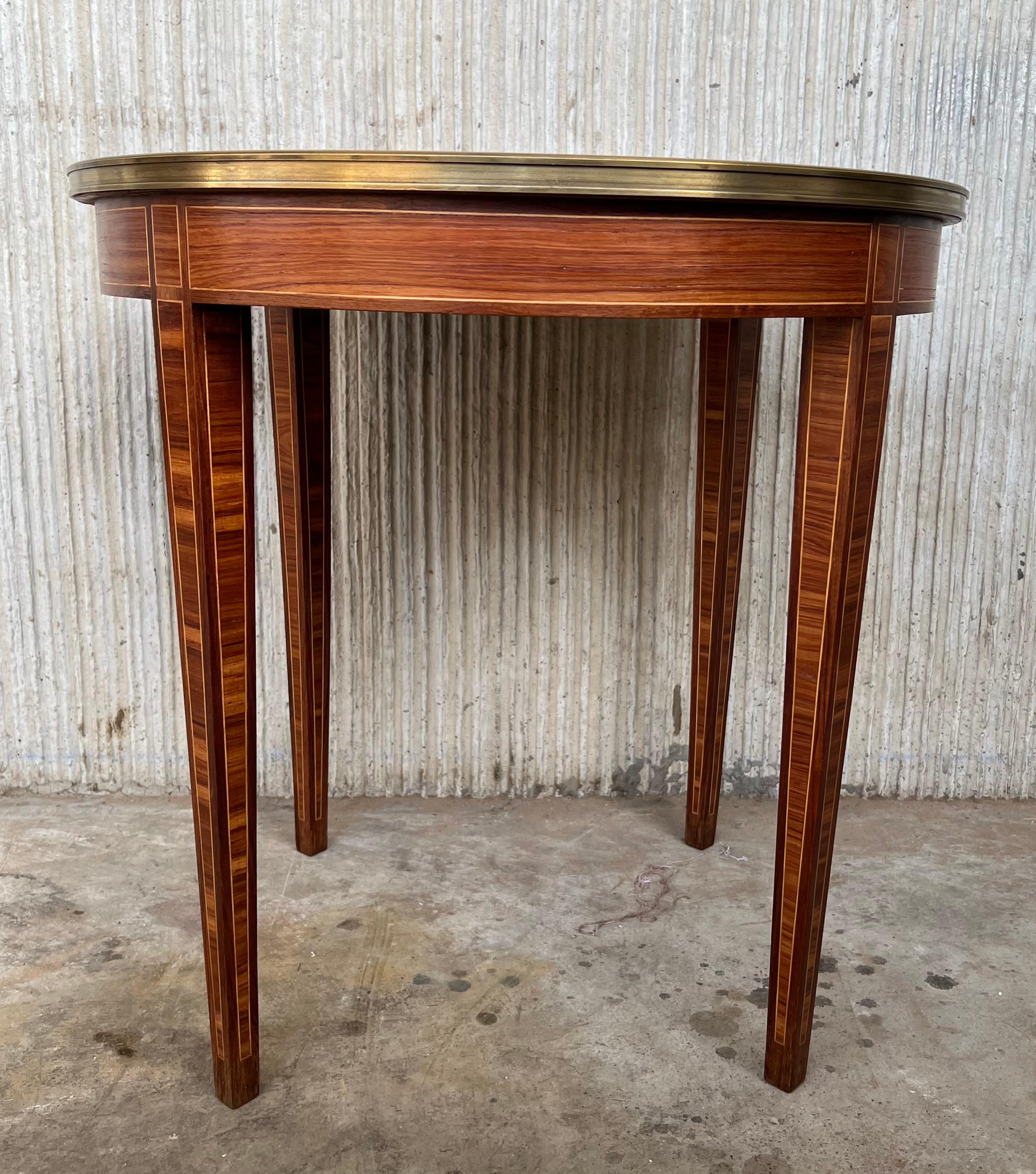 An incredibly fine table of the Belle Époque period, this stunning circular gueridon is designed in the distinct and angular Louis XVI style with tight lines and tapered legs. The surface of the top and around the apron is a complex pattern of