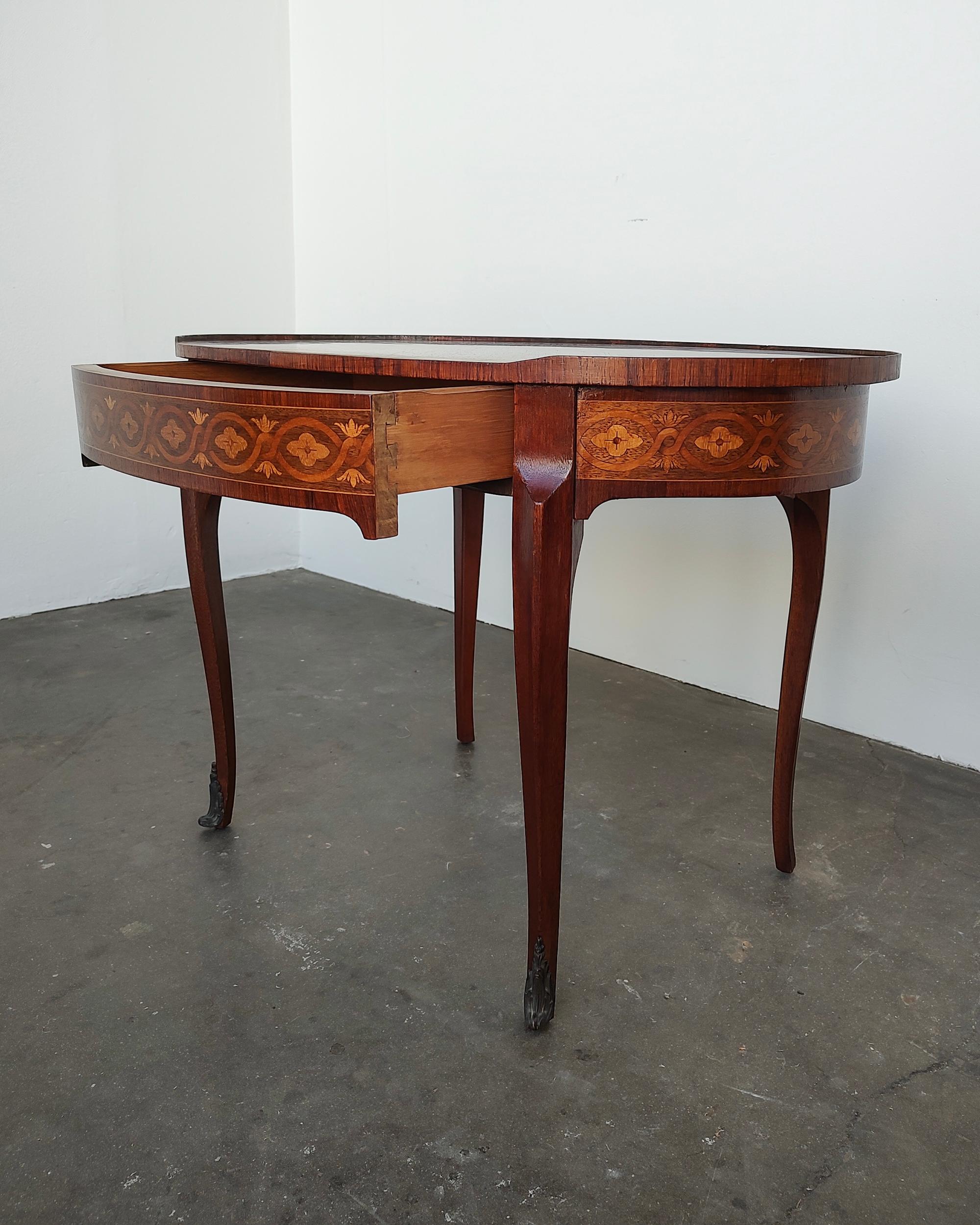A French Louis XVI mahogany oval side table with hidden drawer and starburst veneer top. top with a trellis motif around the skirt. with inlaid side table with a wooden gallery, single central drawer with two leather inset top candle slides, with