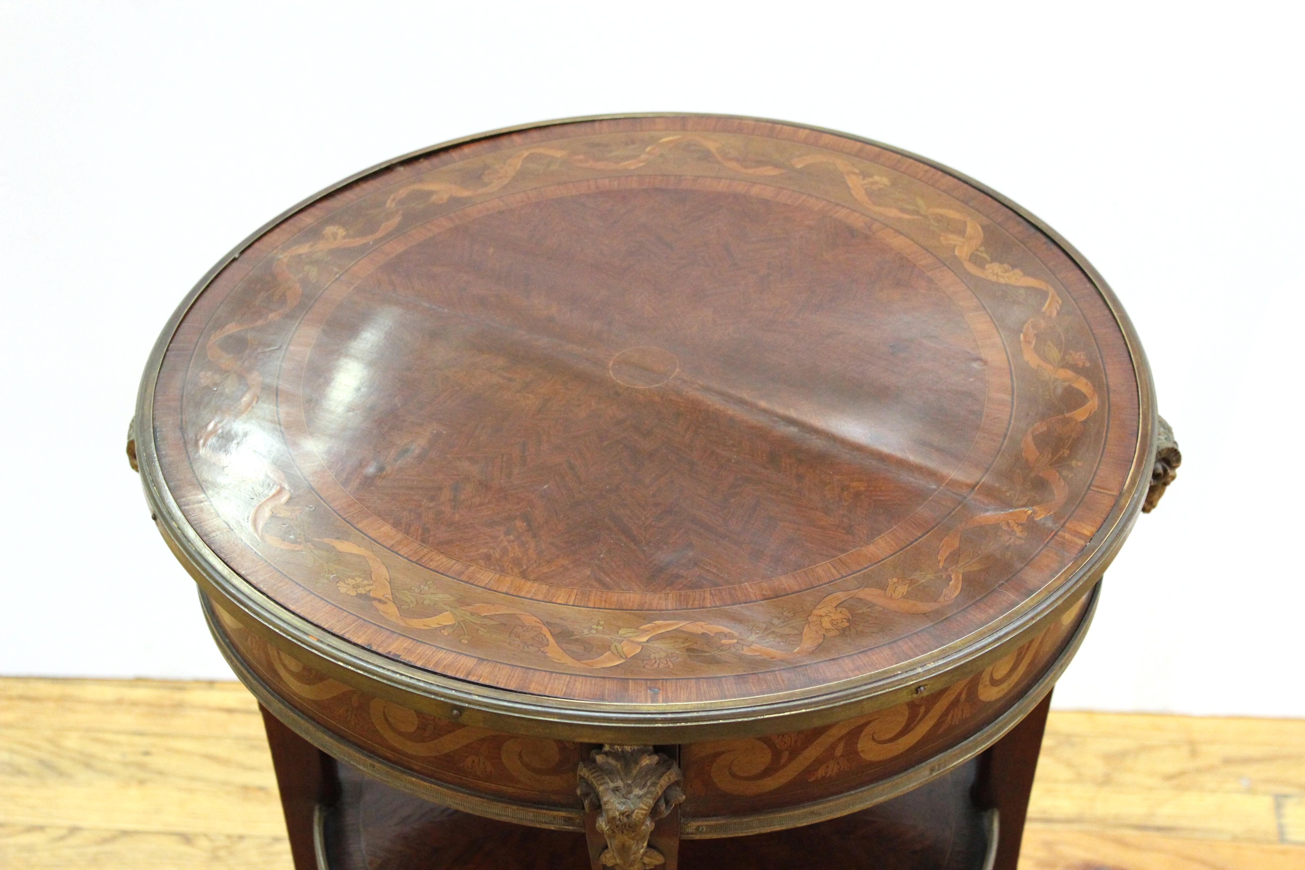 French Louis XVI style marquetry round top side table with gilt bronze mounts, ram-heads with hoof motif sabots. Measures: 30