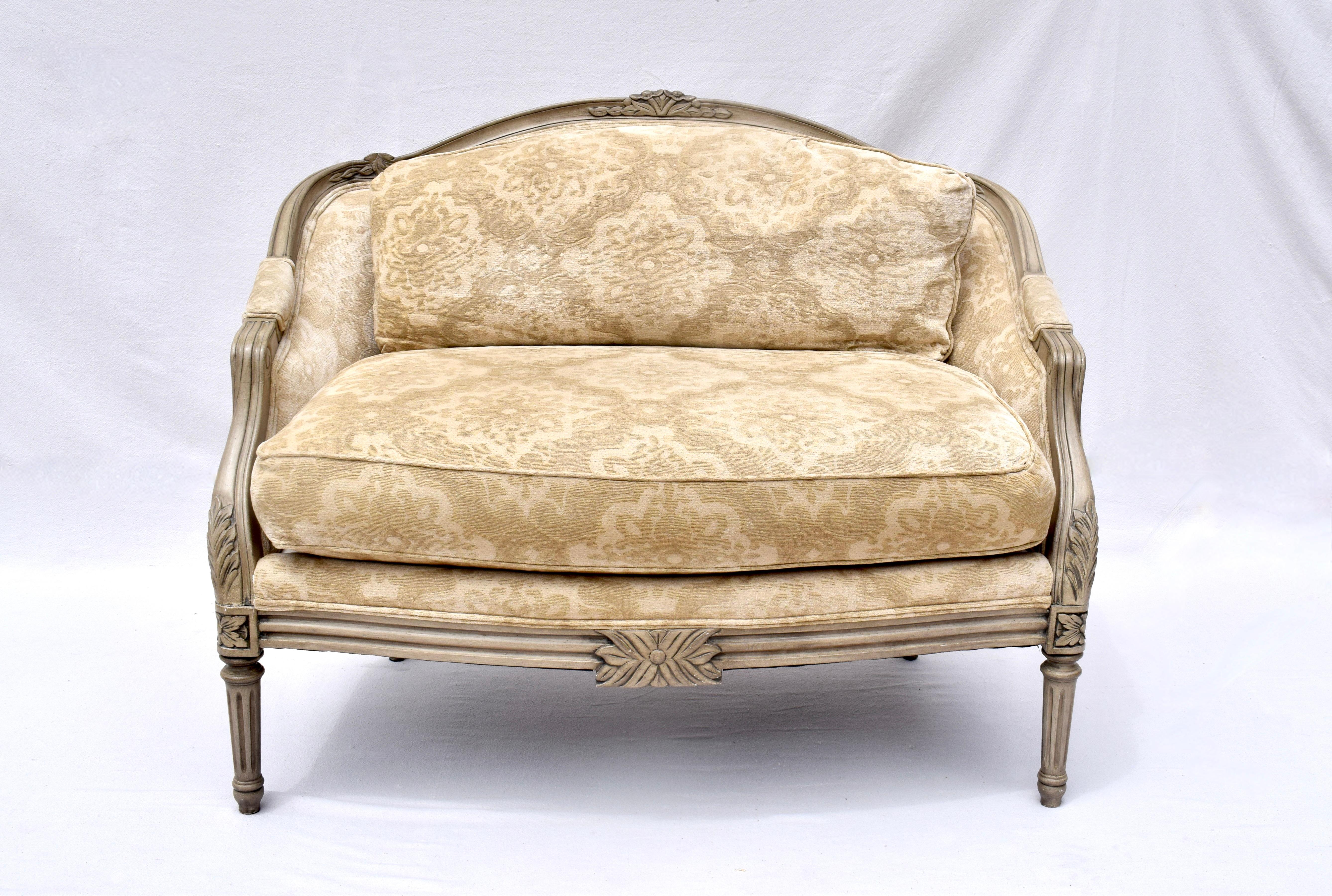 French Louis XvI Style Marquise Bergere Armchair & Ottoman with distinct design elements of the period including hand-crafted Gustavian inspired finish, carved rosette corners atop tapered fluted legs.  The extra wide seat that defines the Marquise
