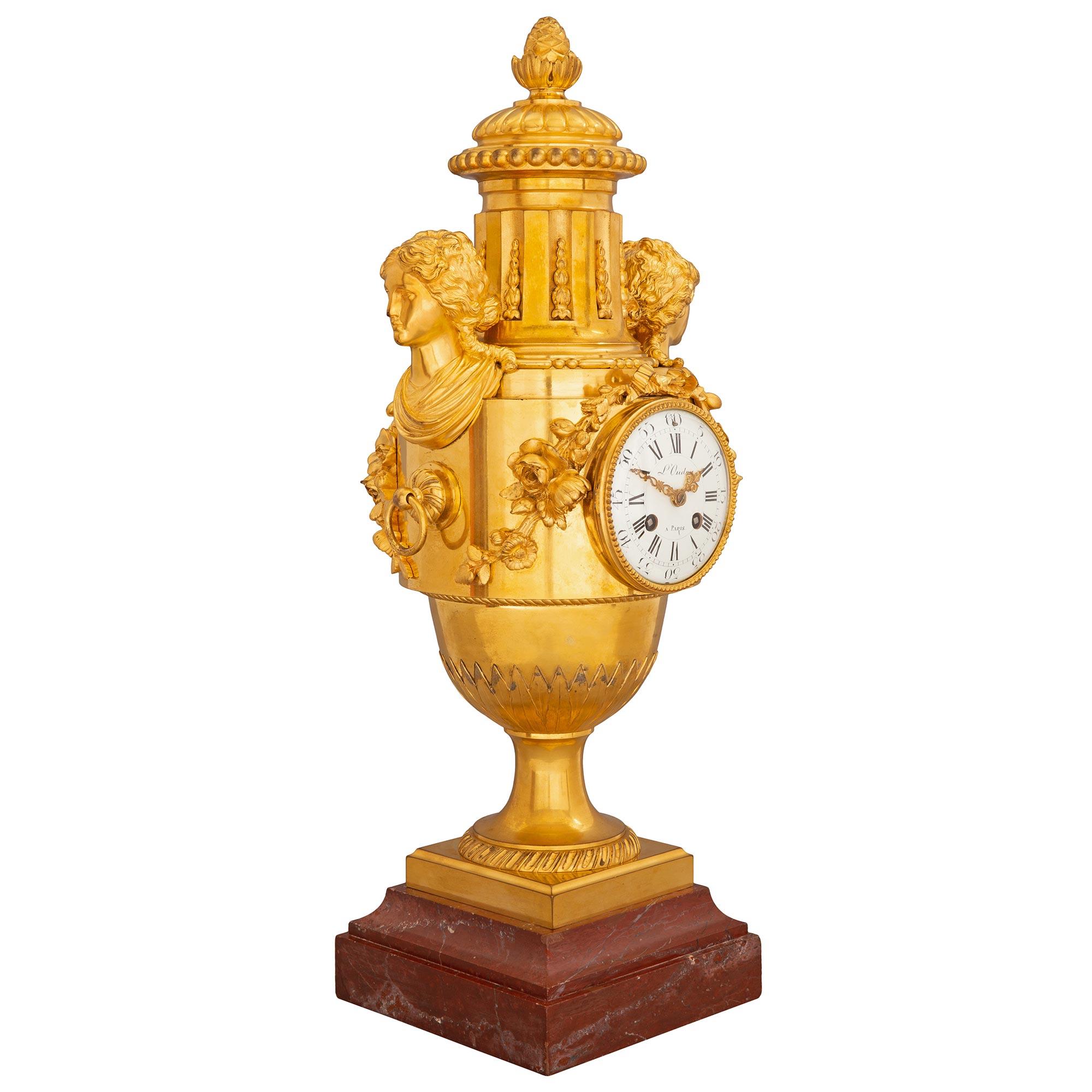 A stunning and very high quality French mid-19th century Louis XVI st. ormolu and Rouge Griotte marble clock, stamped L. Oudry, Paris. The clock is raised by a thick square Rouge Griotte marble base below the ormolu socle shaped pedestal with a
