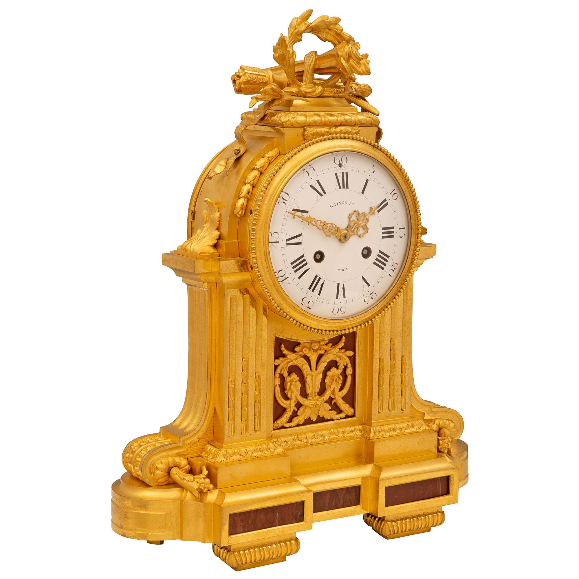 A stunning and extremely high quality French 19th century Louis XVI st. Belle Époque period ormolu and Griotte de Campan Rouge marble clock, signed Raingo Freres, Paris. The clock is raised by elegant reeded block feet below most decorative fitted
