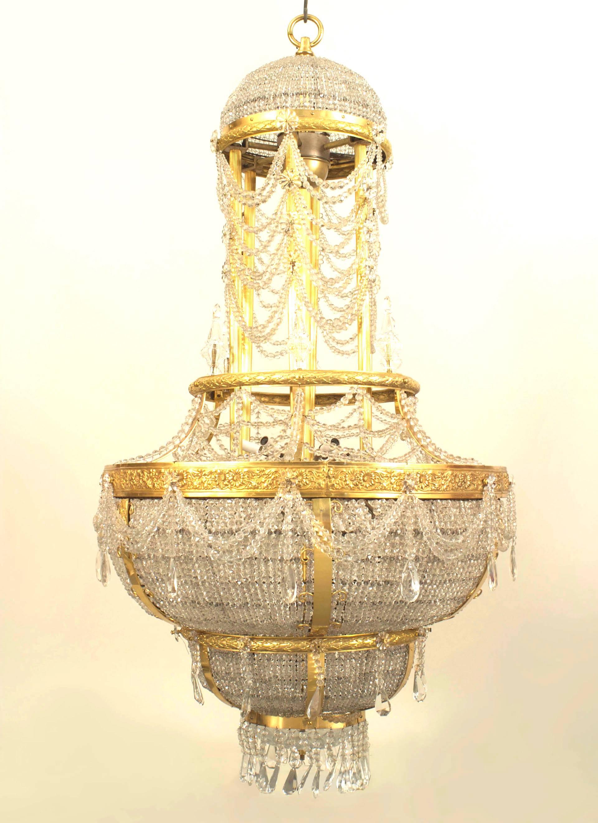 French Louis XVI style (circa 1900) gilt bronze and beaded crystal large
chandelier with a dome form top and swag and festoon design with eight crystal finials.