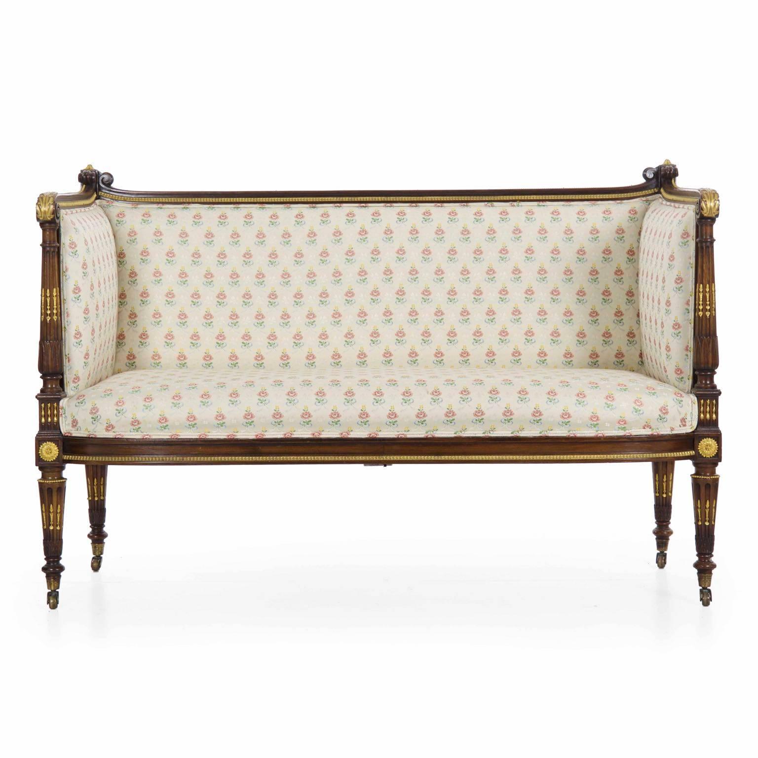This is one of the most pleasing little canapé sofas we’ve brought into the shop in a while. Everything about it is nicely balanced - despite being incredibly well dressed in some of the finest gilt bronze mounts, the slight proportions and totality
