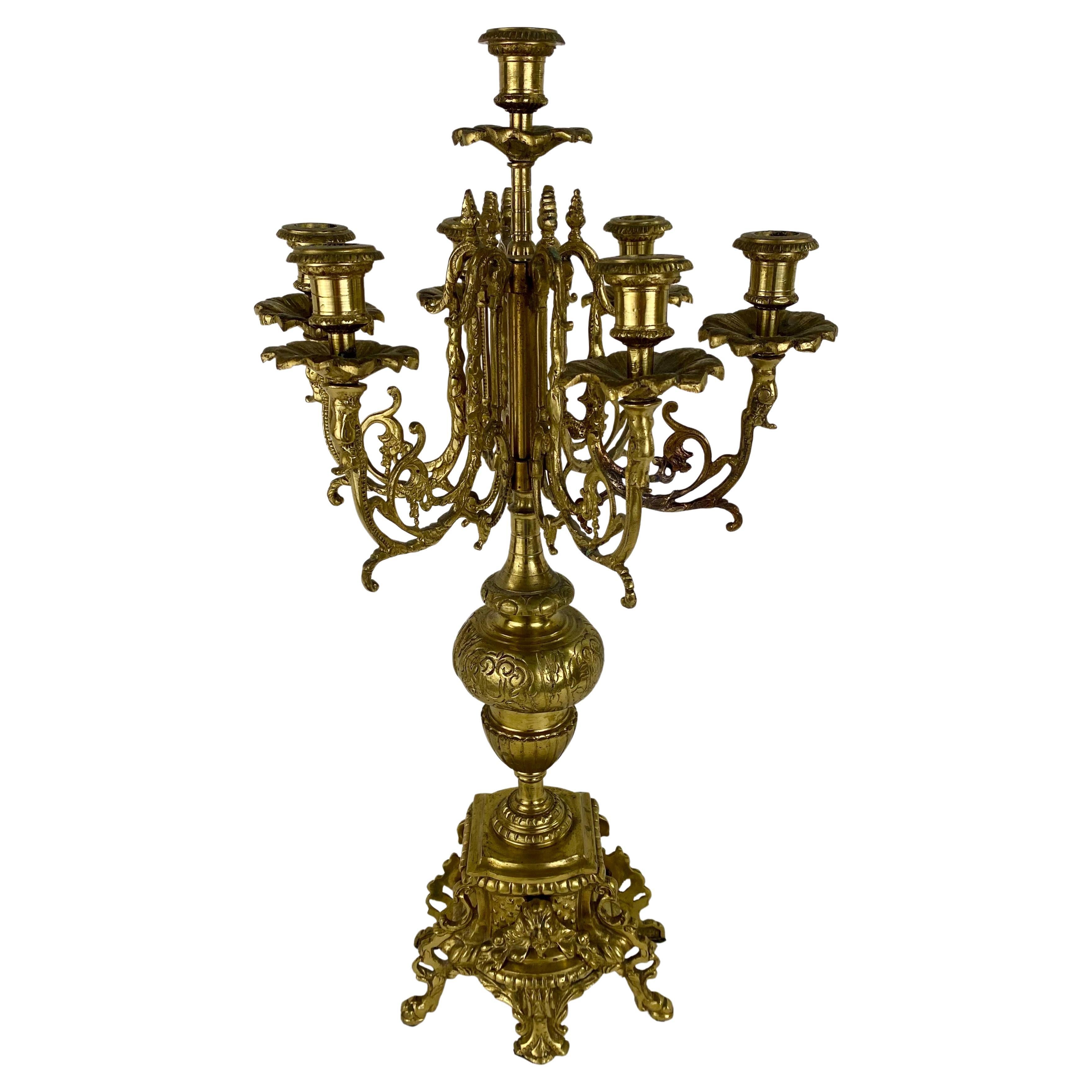 An opulent pair of late 19th century French Louis XVI Ormolu candelabras. Each Candelabra is boasting seven candle arms beautifully designed with scrolls  and acanthus motifs and ending in a floral shaped bobeches.  The candelabras are standing on a