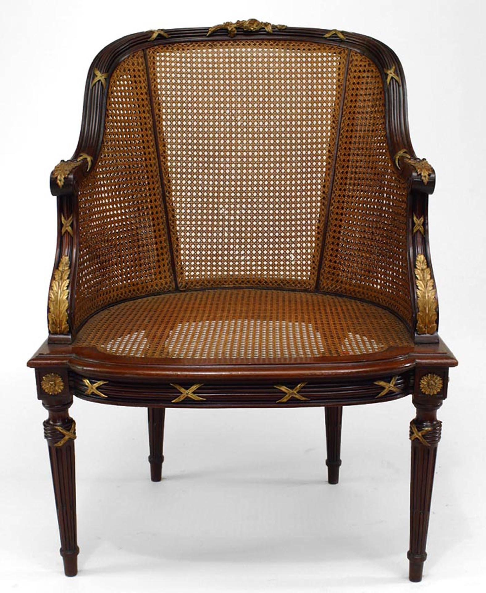 French Louis XVI style ormolu-mounted mahogany caned bergere (late 19th century). Matching ottoman Dealer reference number #050651B. 