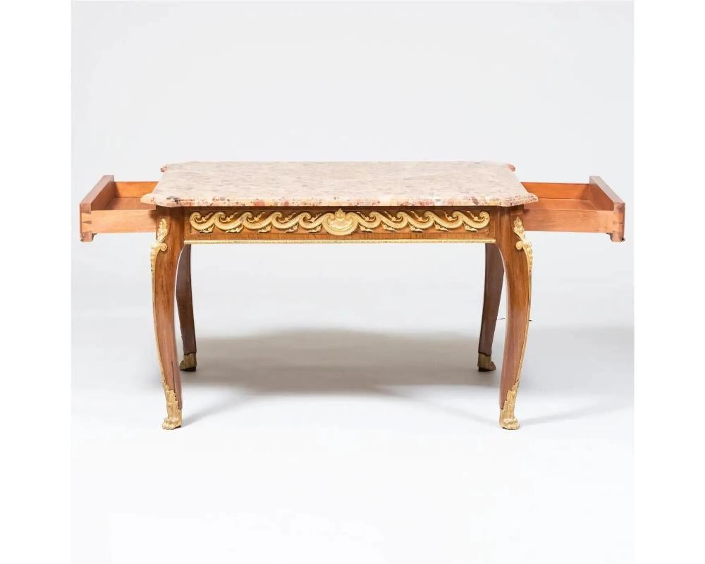 A French Louis XVI Style Ormolu-Mounted Mahogany Coffee Table, C. 1880 fitted with a Breche d 'Alep marble top and two end drawers.

A remarkable piece that showcases the elegance and craftsmanship characteristic of the Louis XVI era. Crafted in the