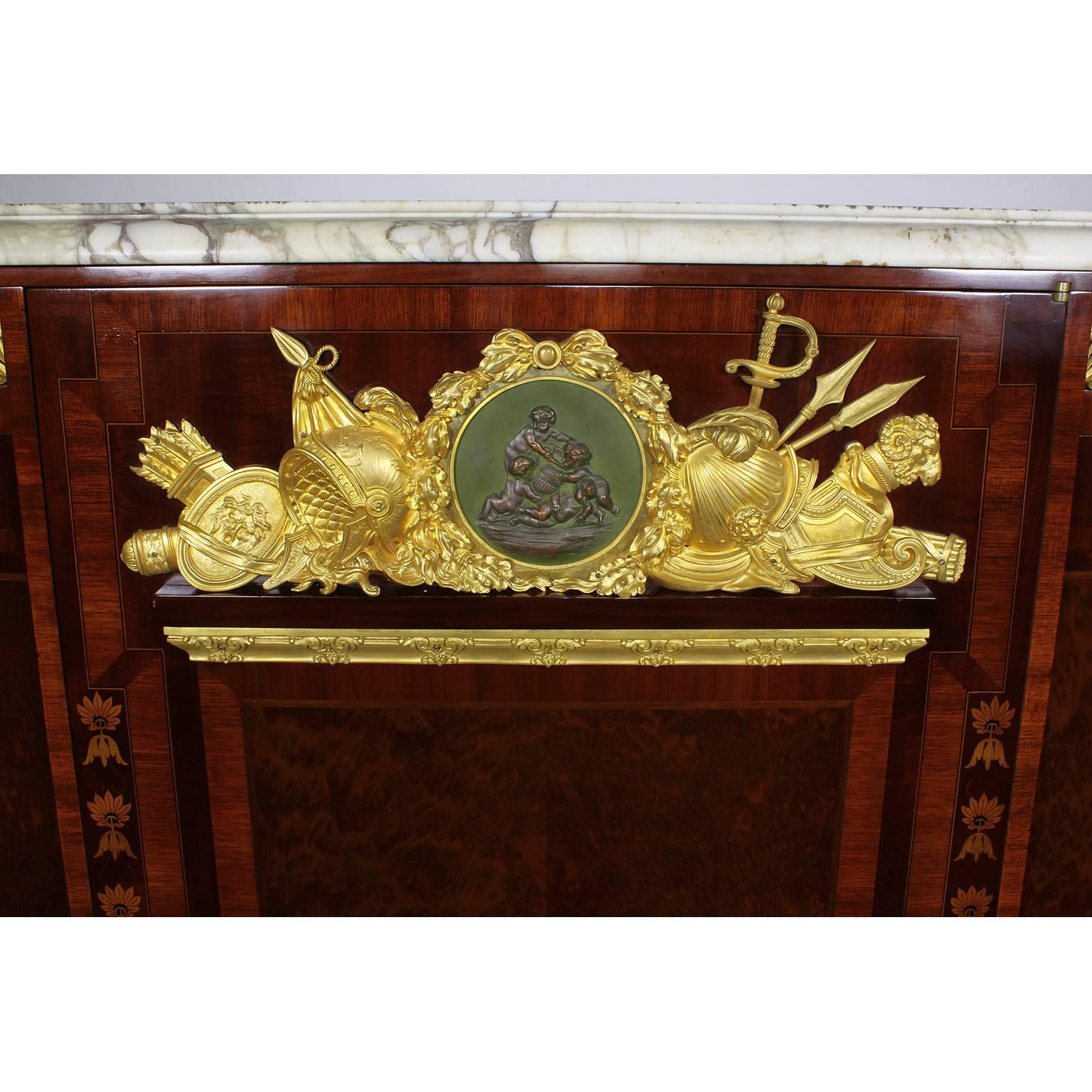 A very fine French 19th century Louis XVI style burr-walnut and mahogany marquetry and ormolu-mounted Military armorial Meuble D'Appui with a Veined Brèche Violette marble top, attributed to Mâison Millet, Paris. The tall and narrow three-door