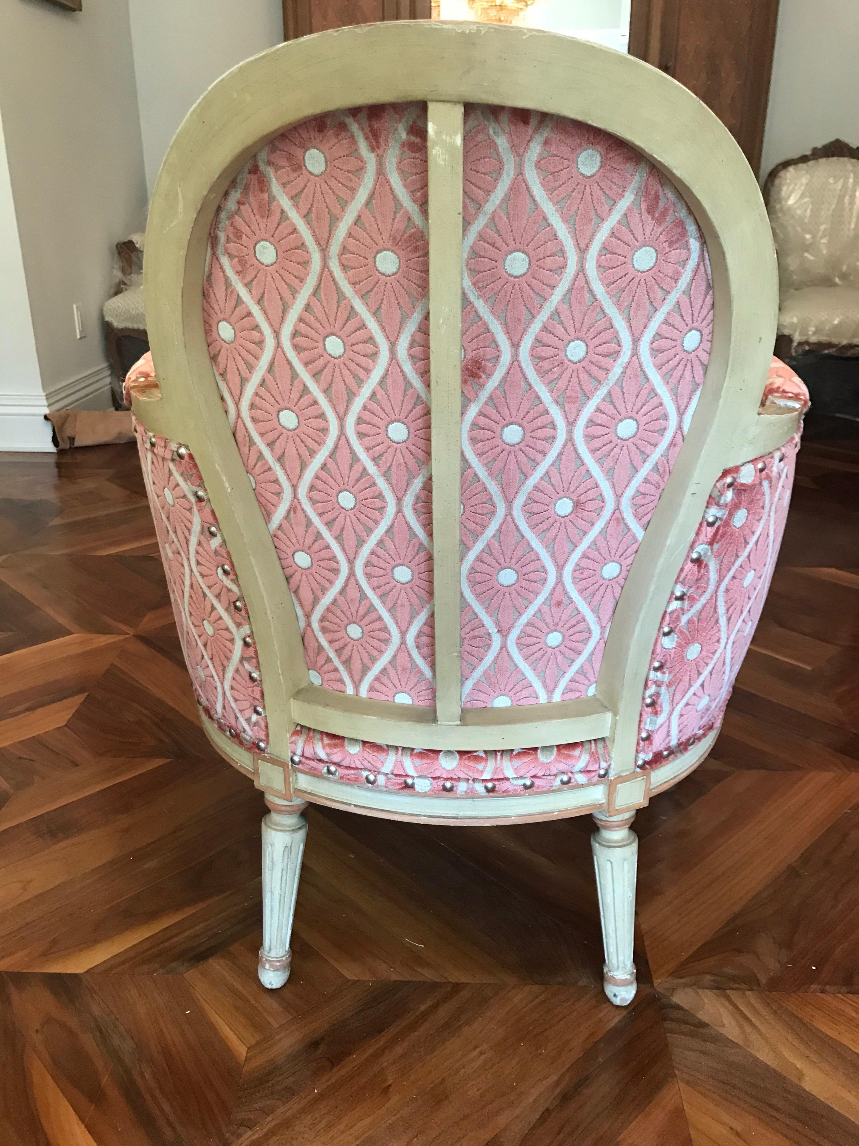 Sumptuous pair of French Louis XVI bergère chairs featuring painted frames and new velvet upholstery, circa 1920s, these chairs have a deco feel in the proportions. The velvet upholstery is from Brunschwig & Fils and is in a jacquard woven cut