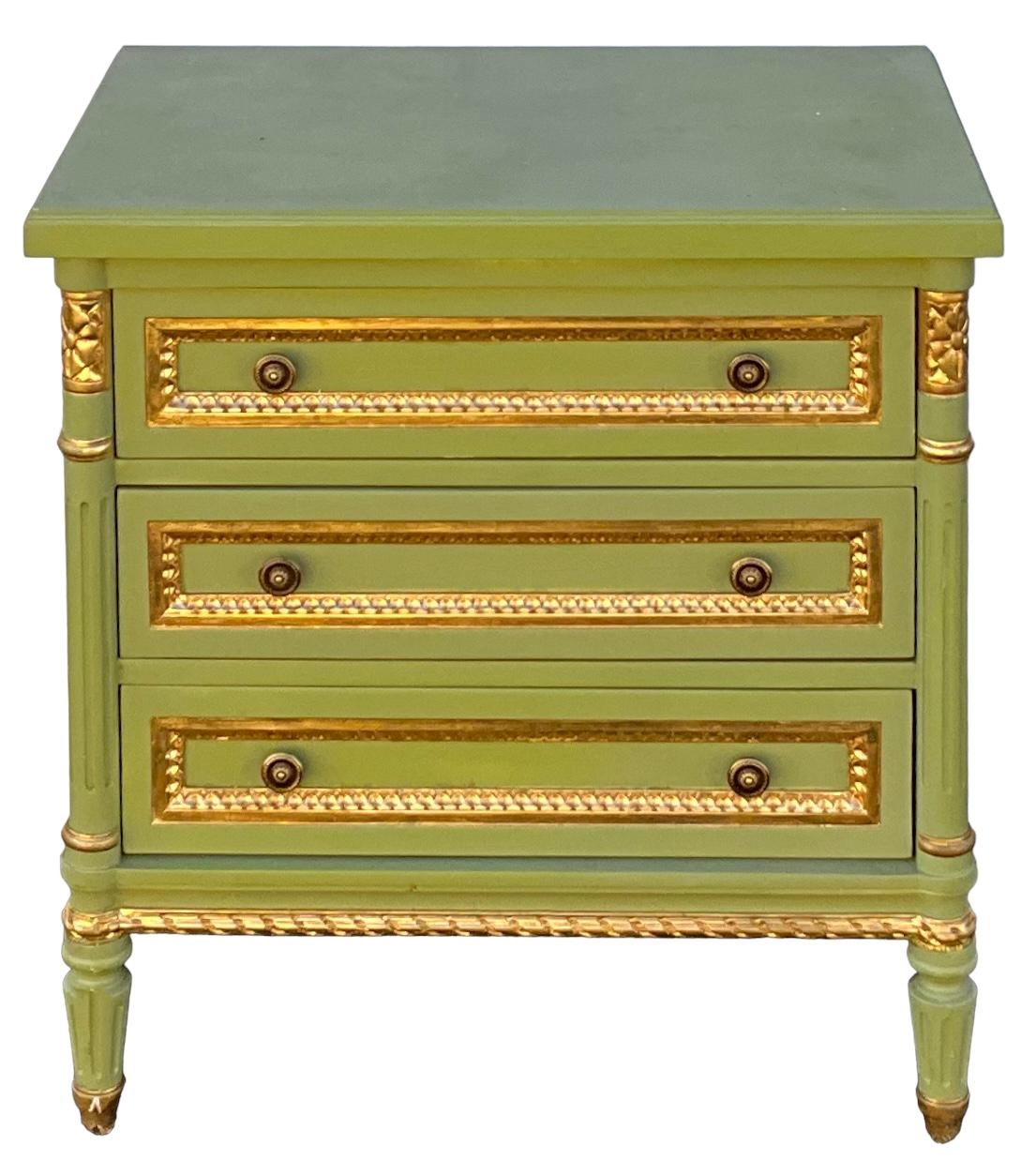 This is a pair of French Louis XVI style chests or side tables attributed to Julia Gray. They are green with gilt accents and have three drawers. They are in very good condition.