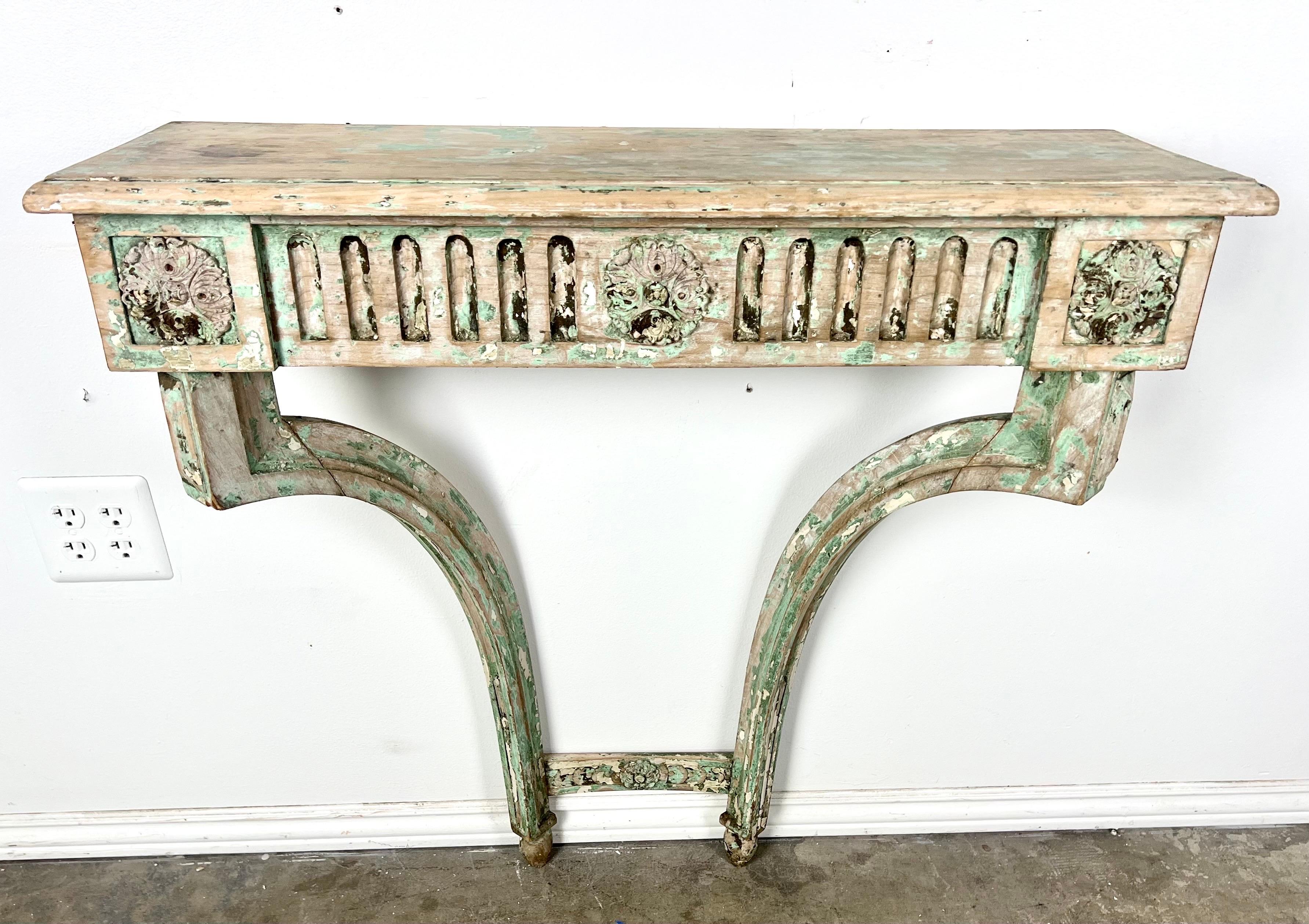 Early 19th century painted console and mirror Italian Louis XVI style.  The mirror has an oil painting depicting a whimsical scene of a man bowing to a woman and another onlooker.  Beautiful worn, robin's egg painted finish, beautiful carving with