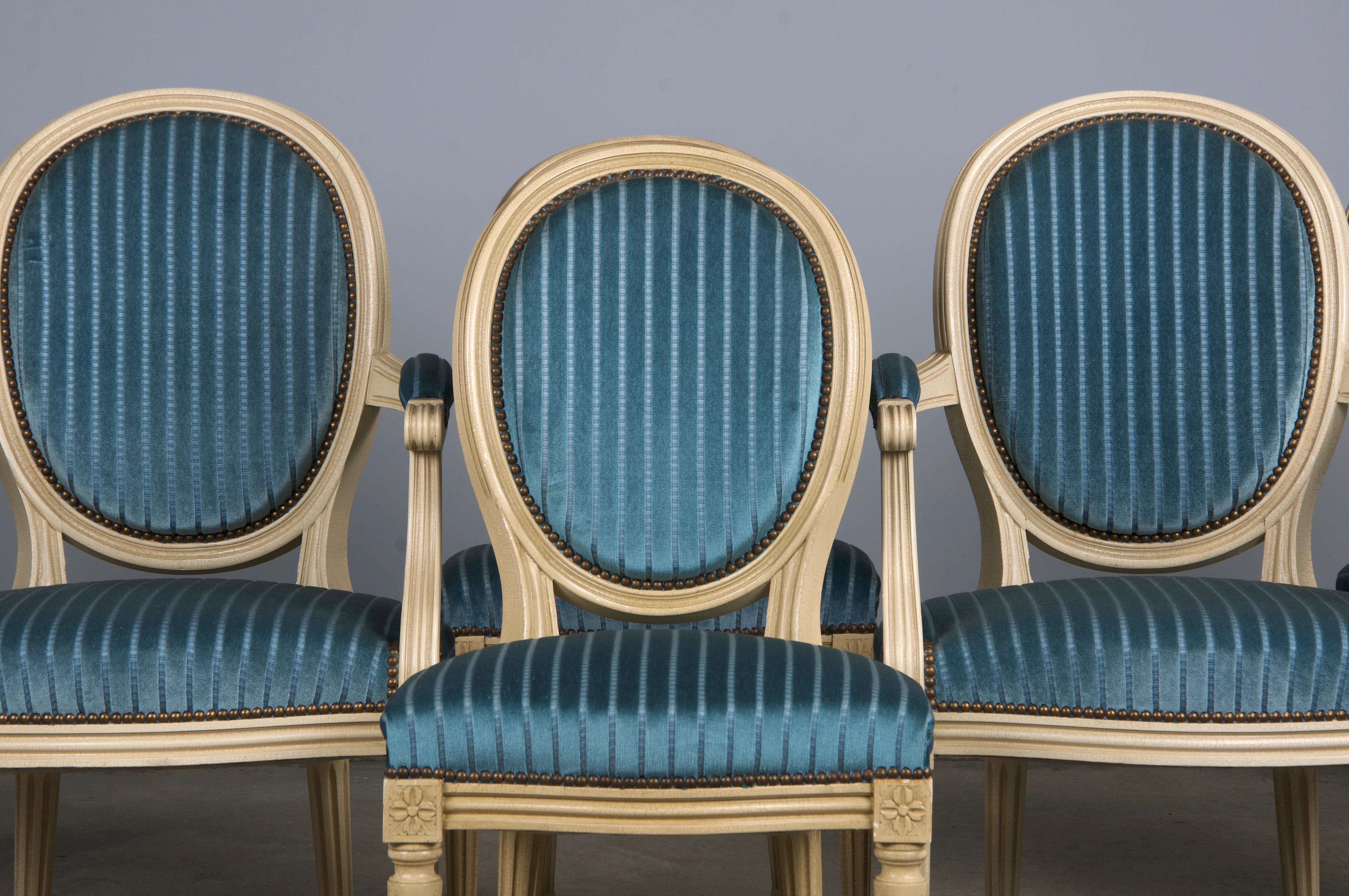 An exquisite set of early 20th-century French dining chairs in the Louis XVI style, sourced from Provence, France. This set includes six side chairs and two armchairs, all meticulously hand-crafted from solid wood with elegant oval-shaped medallion