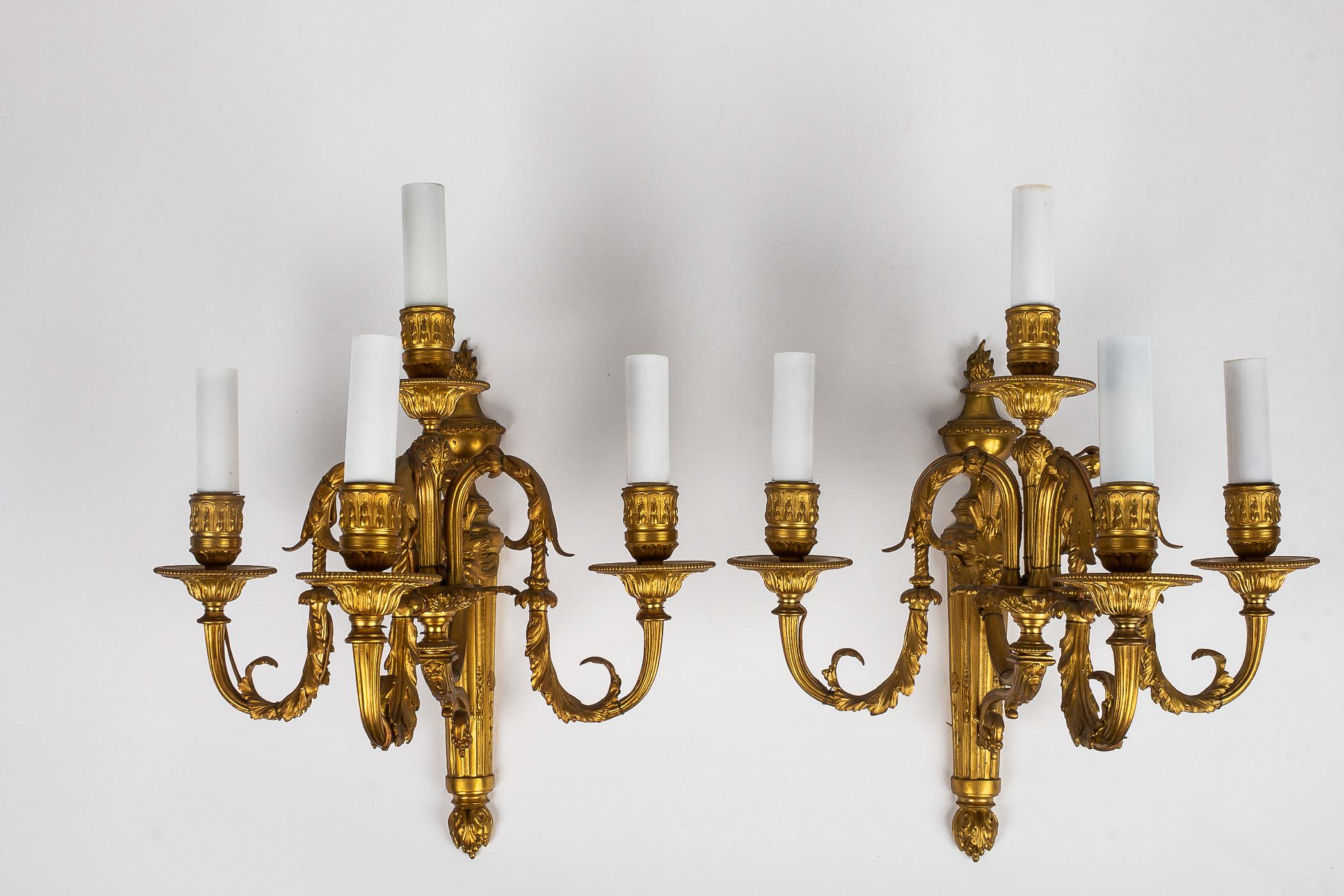 French Louis XVI style, pair of small chiseled ormolu sconces, circa 1880.

An elegant and decorative pair of four arm-lights finely chiseled ormolu sconces, decorated with an urn, grooves and Acanthus leaves. 
Beautiful original gilding.