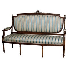French Louis XVI Style Parcel-Gilt Carved Walnut Parlor Settee, 19th Century