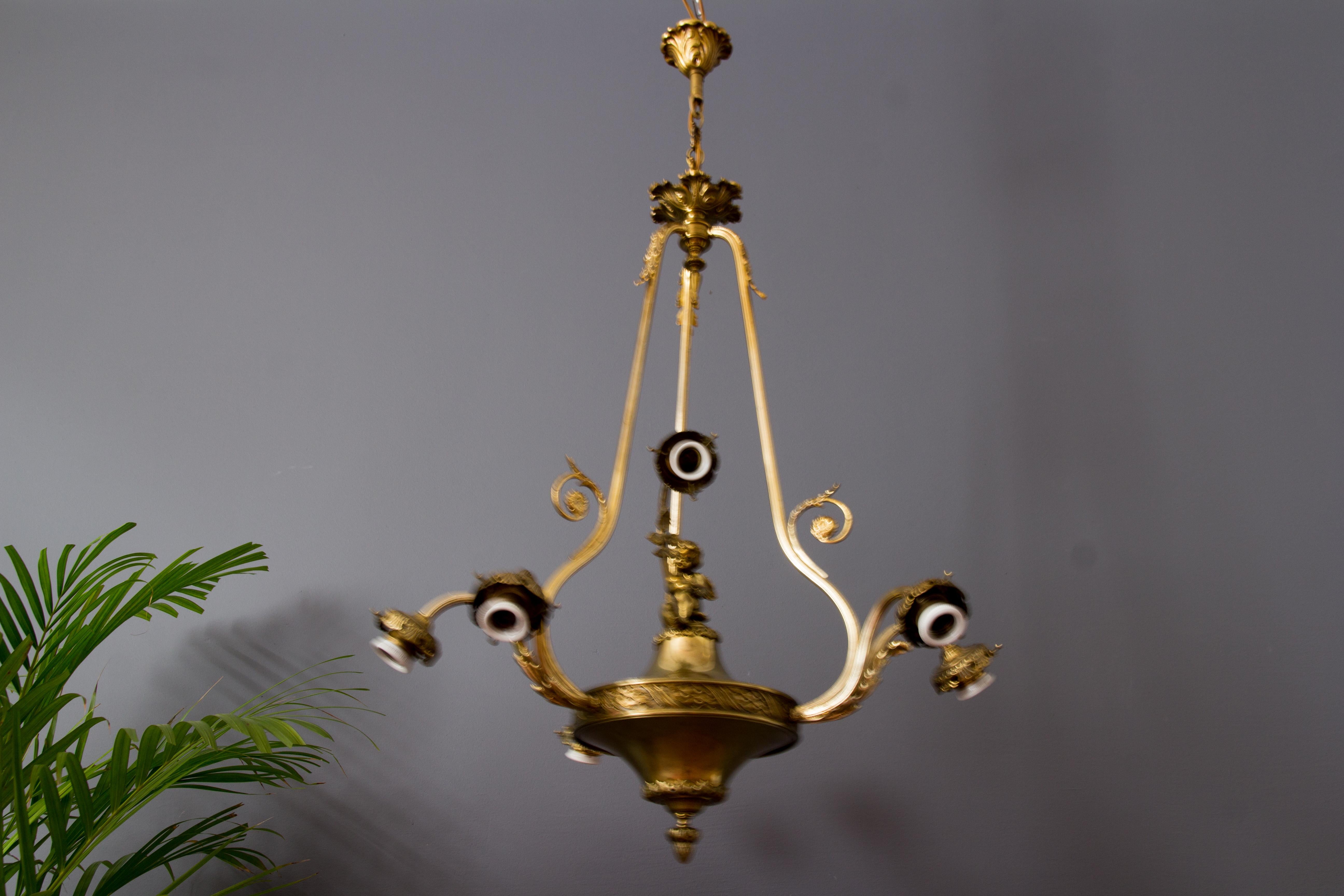 French Louis XVI Style Seven-Light Brass, Bronze and Glass Cherub Chandelier 2