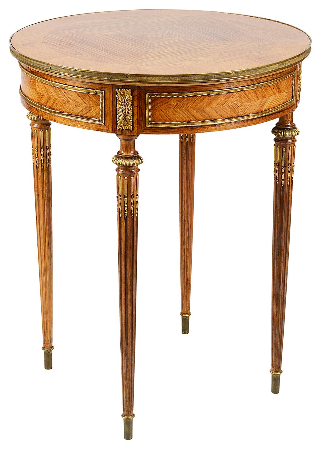 A good quality late 19th century Kingwood veneered circular side table or gueridon. Having a quartered veneered top with crossbanding, ormolu mounts to the panelled frieze, raised on turned tapering stop fluted legs.