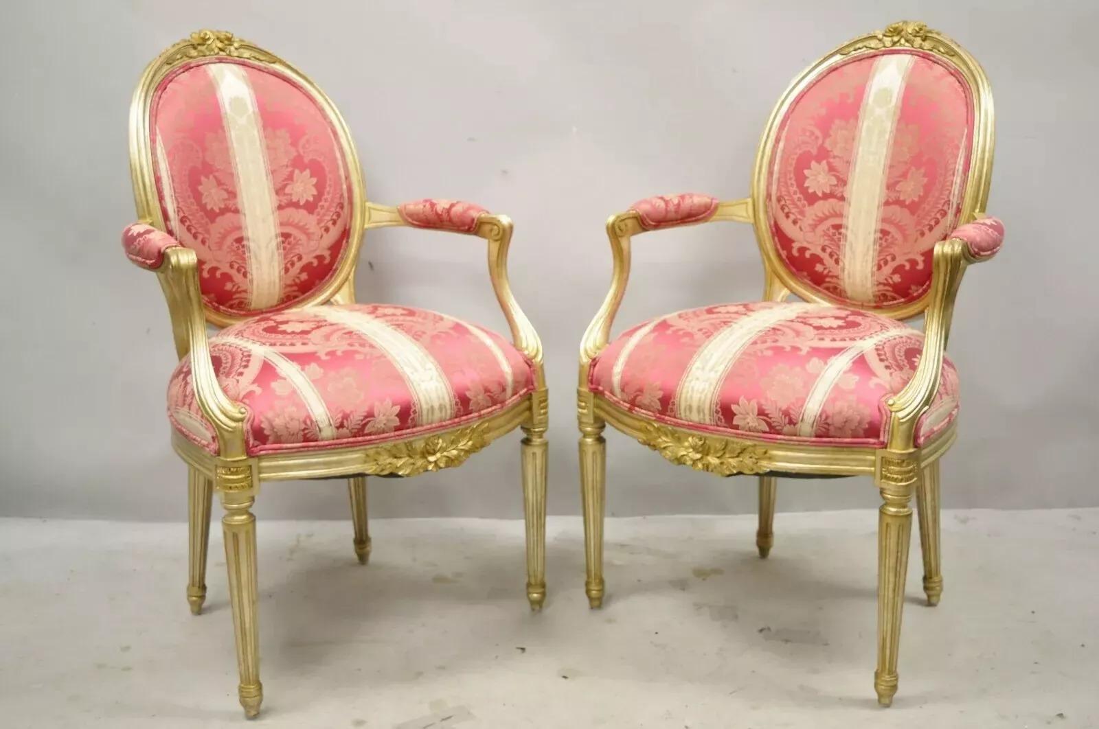 French Louis XVI Style Silver and Gold Gilt Pink Damask Oval Back Arm Chairs - a Pair. Item features silver/gold gilt finish, burgundy velvet upholstered rear backrests, pink floral damask upholstery, oval medallion backs, and quality craftsmanship.