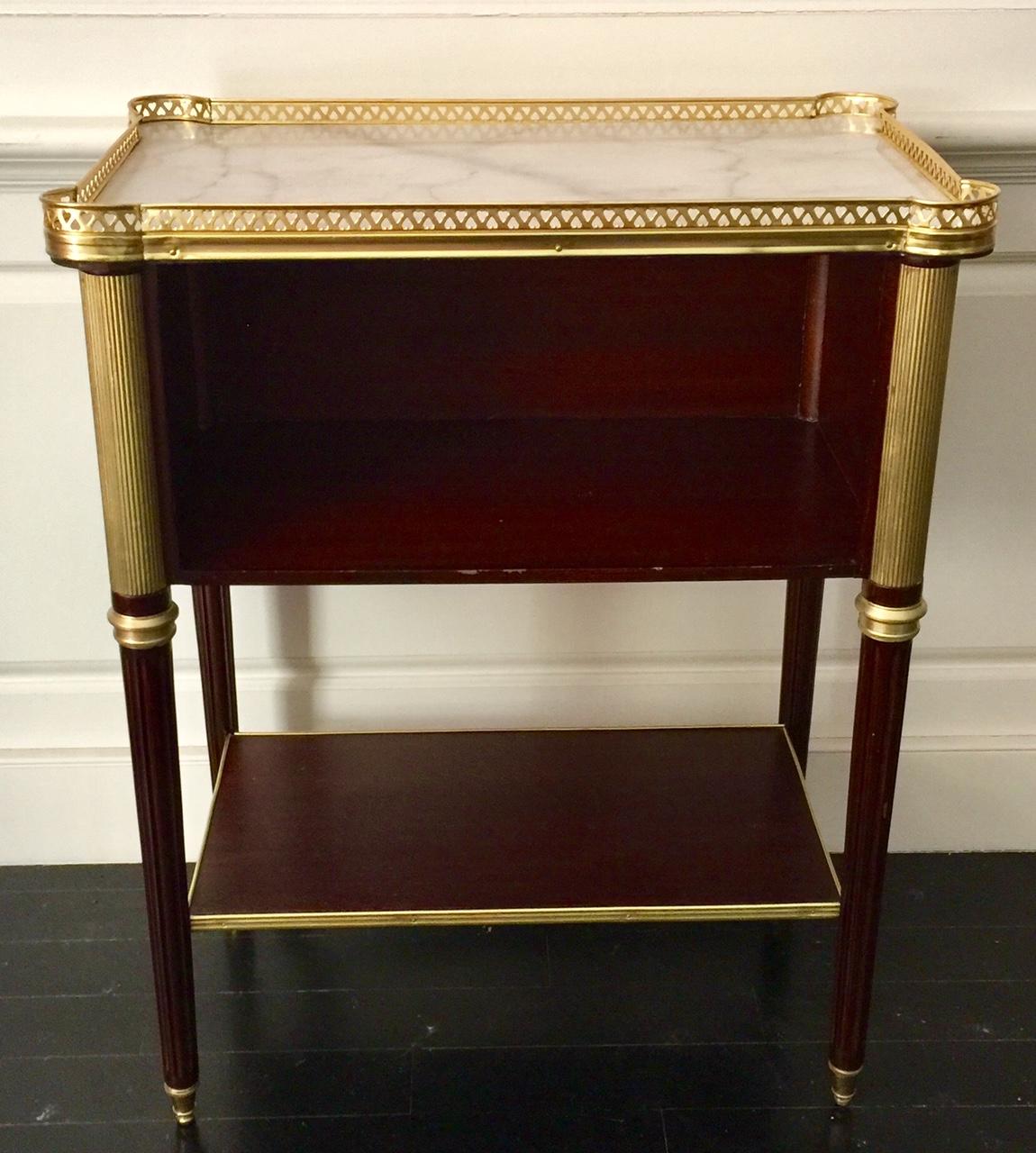 French Louis XVI style table in the manner of Maison Jansen
This lovely contemporary occasional table or nightstand was inspired by a Maison Jansen Telephone Table. Gallery top with pierced frieze. Open front cabinet. Great style at a lower price,