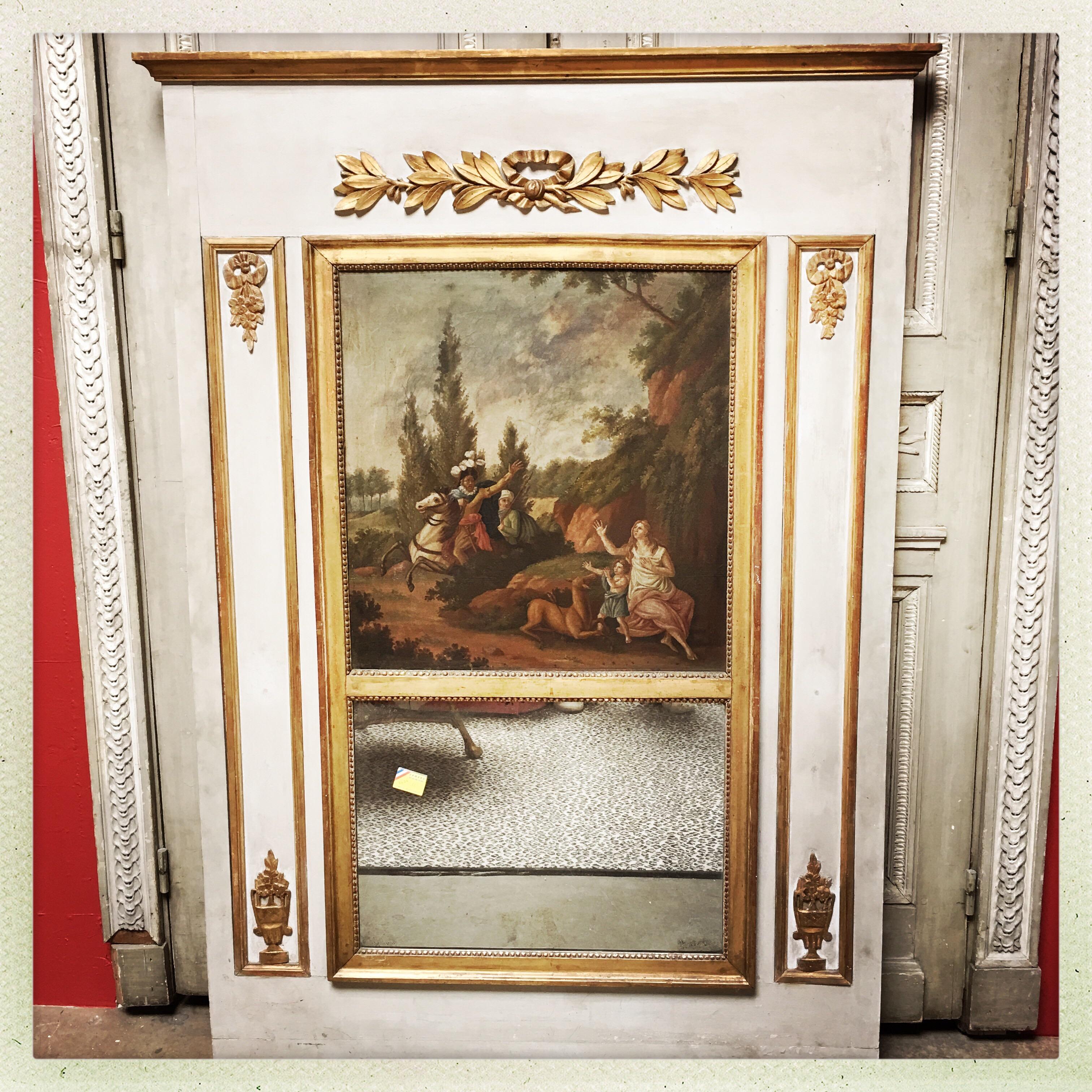 A French Louis XVI style trumeau mirror with a painted and parcel gilded finish with an oil painting depicting Chevalier.