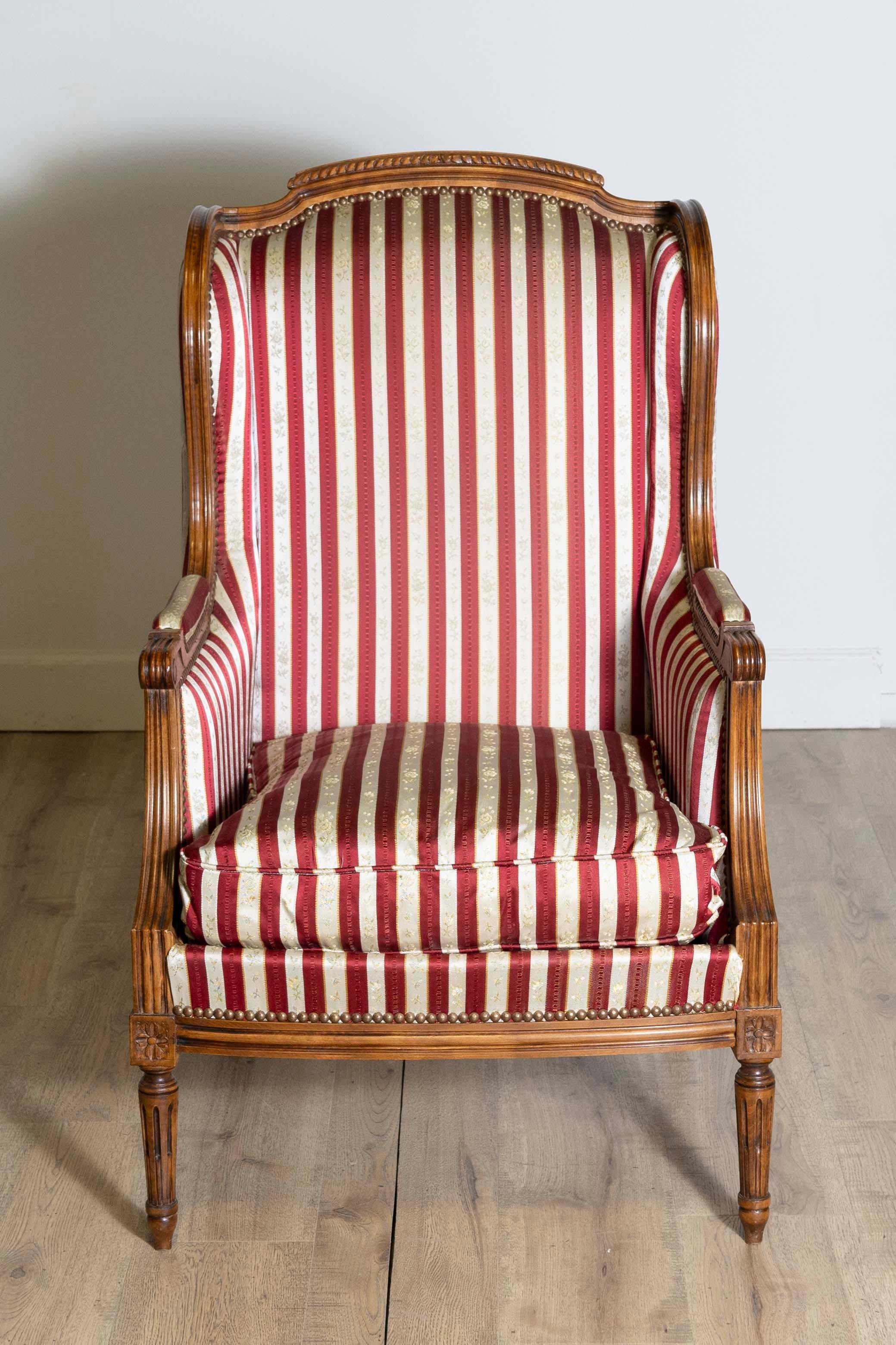 Carved French Louis XVI Style Walnut Bergères à Oreilles with Fluted Legs, a Pair For Sale