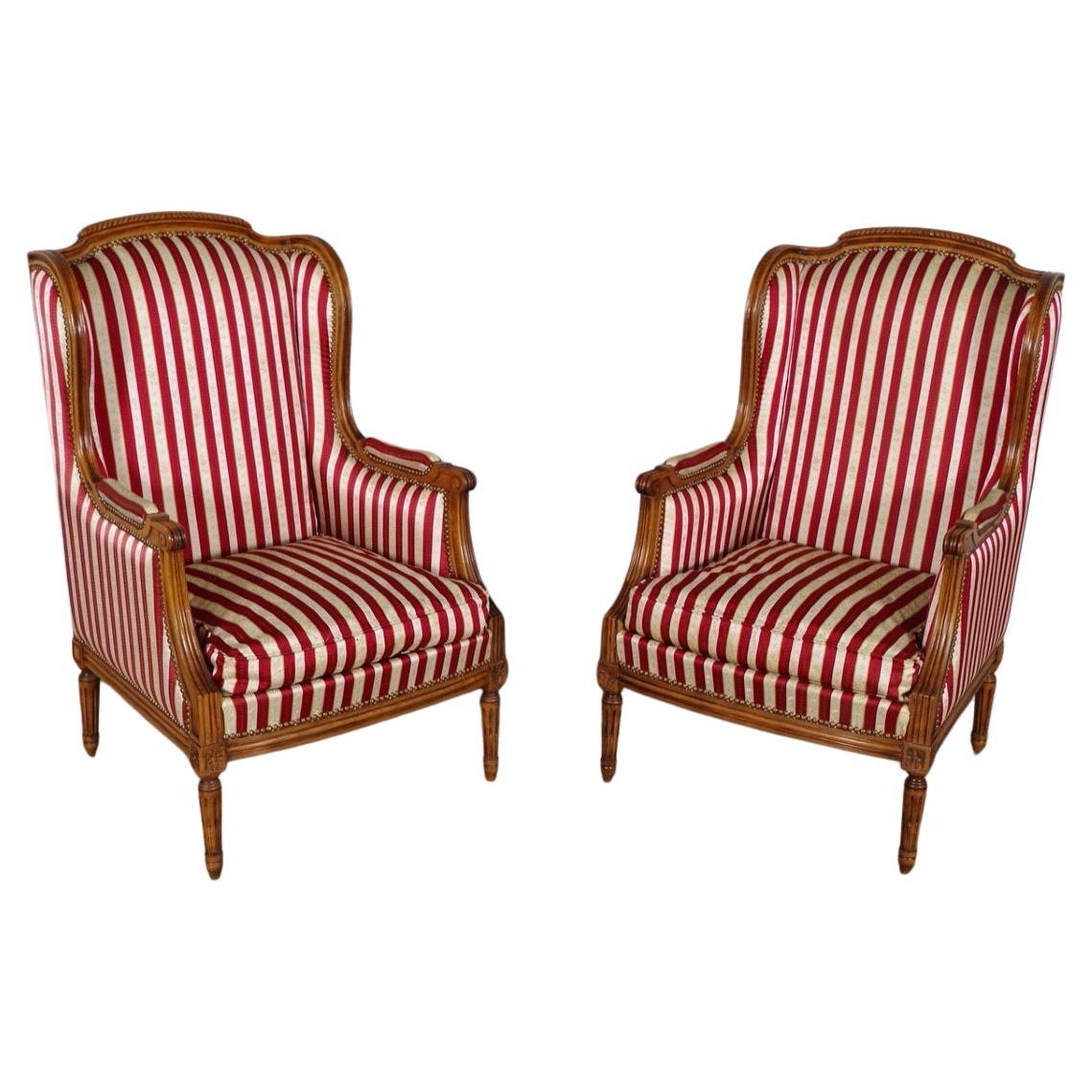 French Louis XVI Style Walnut Bergères à Oreilles with Fluted Legs, a Pair