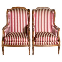 French Louis XVI Style Walnut Bergères à Oreilles with Fluted Legs, a Pair