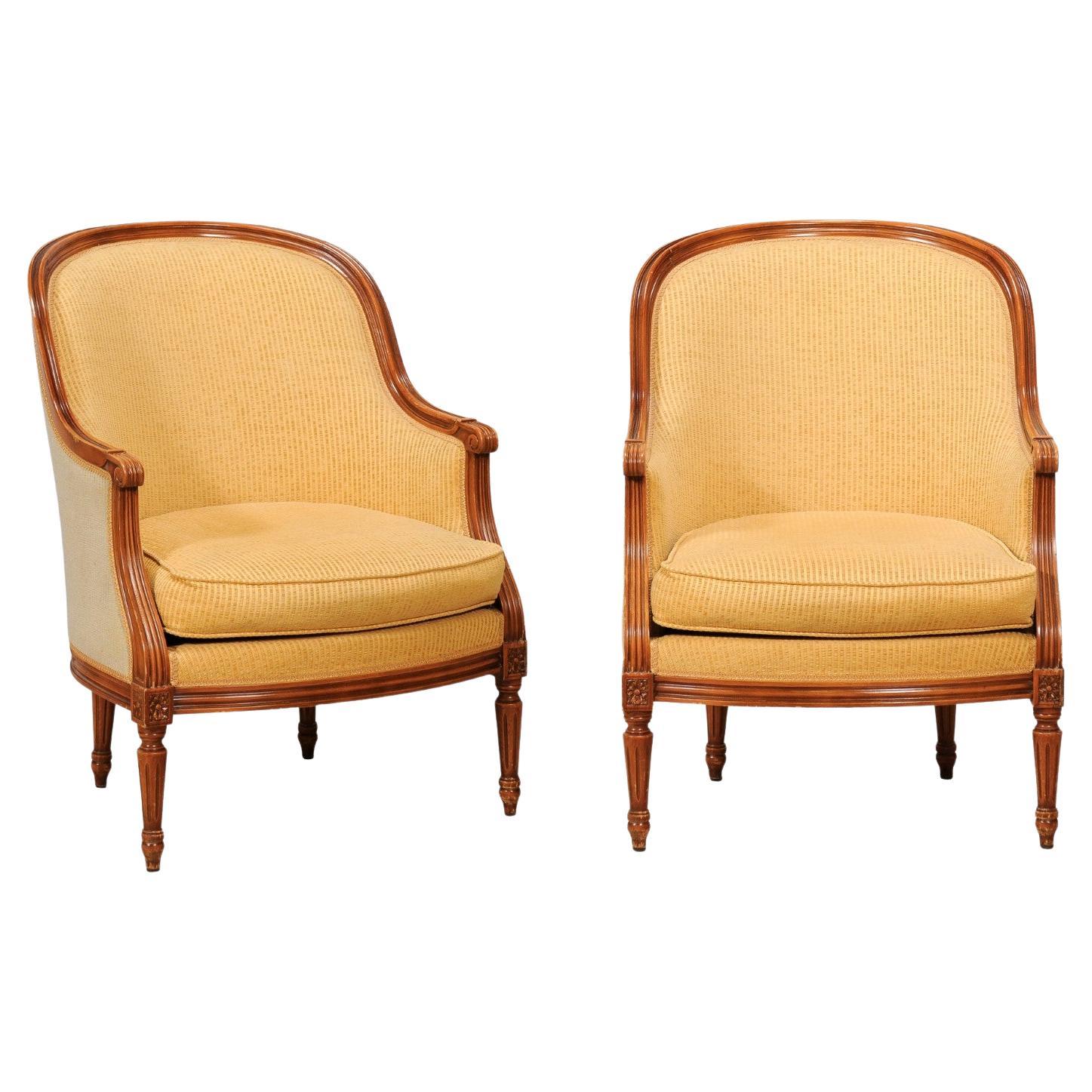 French Louis XVI Style Walnut Bergères Chairs with Wraparound Backs, Pair For Sale