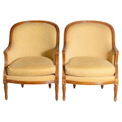 French Louis XVI Style Walnut Bergères Chairs with Wraparound Backs, Pair
