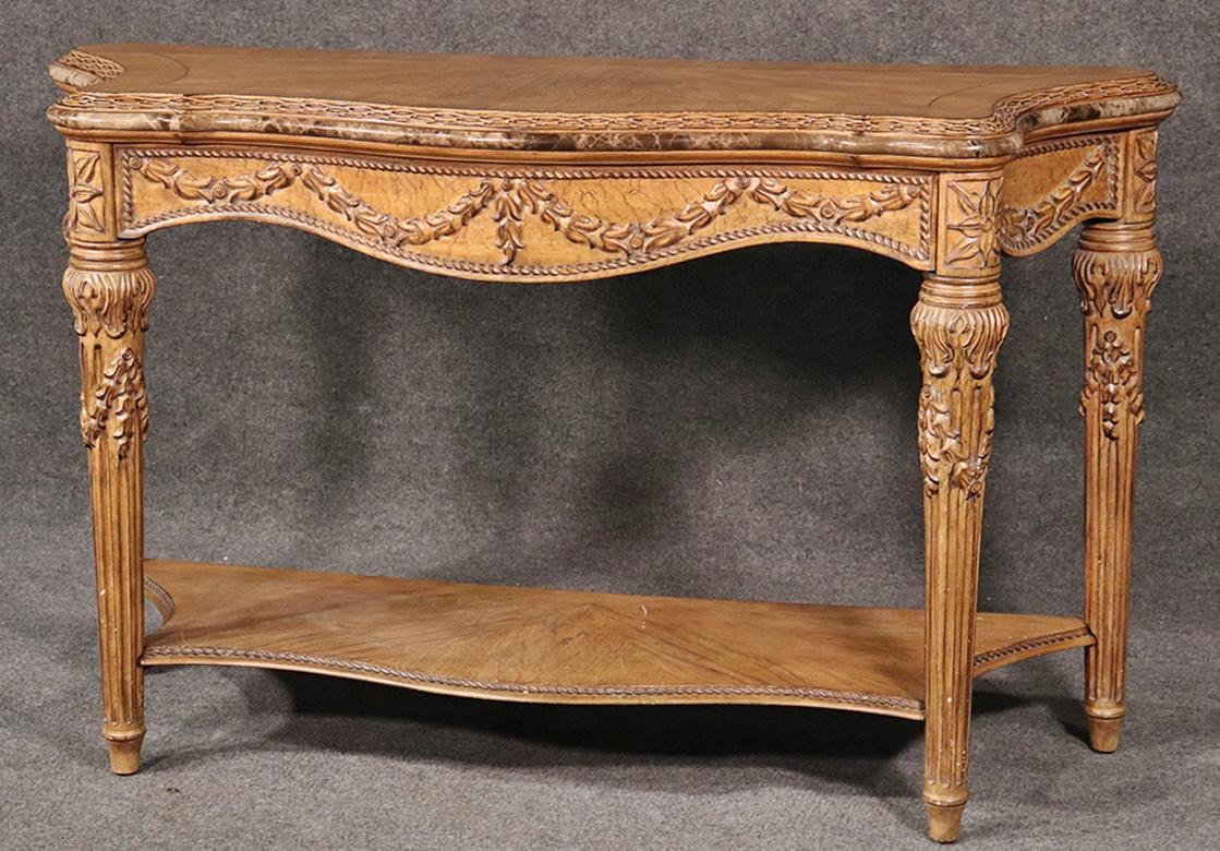 Carved walnut French Louis XVI style painted console table with marble trim that runs around the table top.