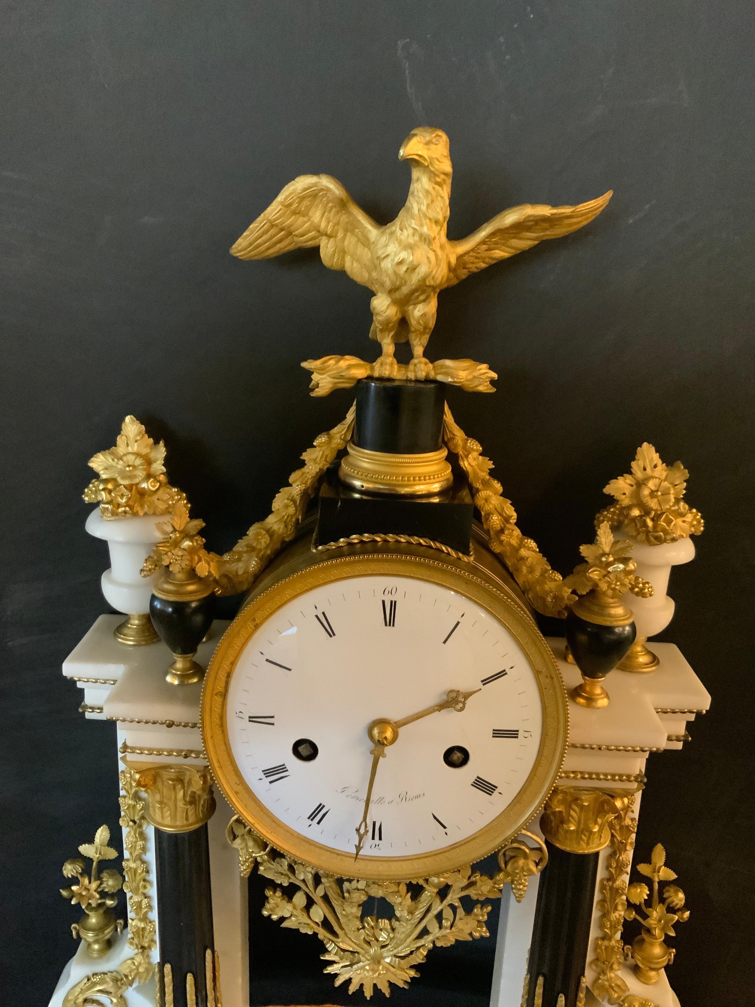 Exceptional because it is a beautiful case of Carrara marble with black
Fluted columns, with bronze dore eagle crest, framed by urns filled with fruit
And flowers, white enamel dial with Roman numeral hour markers, signed
persevalle a Reims, time