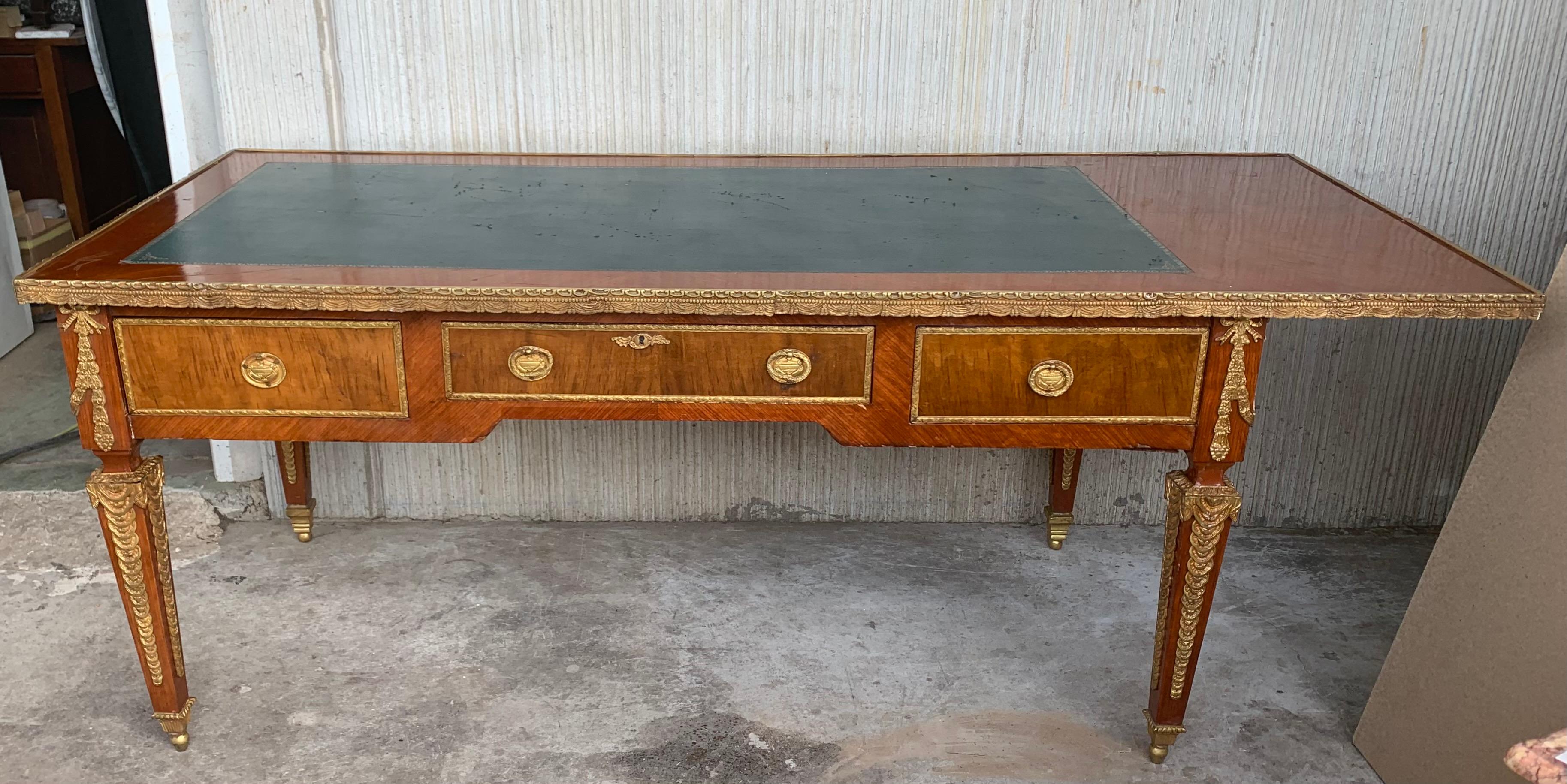 Crafted in Paris, France, circa 1870 in the style of Francois Linke and built of walnut , the large antique desk stands on elegant cabriole legs decorated at the shoulder with bronze figural floral decorations, and ending with gilt bronze sabots at