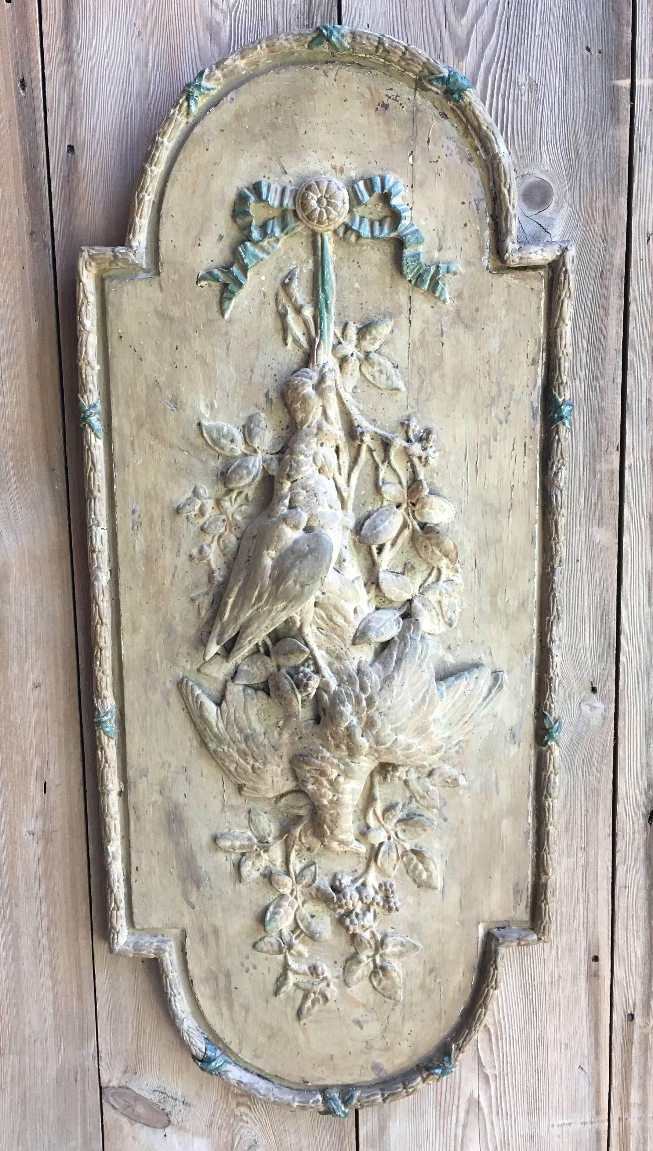 A French Louis XVI decorative trophy panel from a boiseries, late 18th-early 19th century, depicting the hunt with game birds and garlands, the edge bordered in a carved molding.