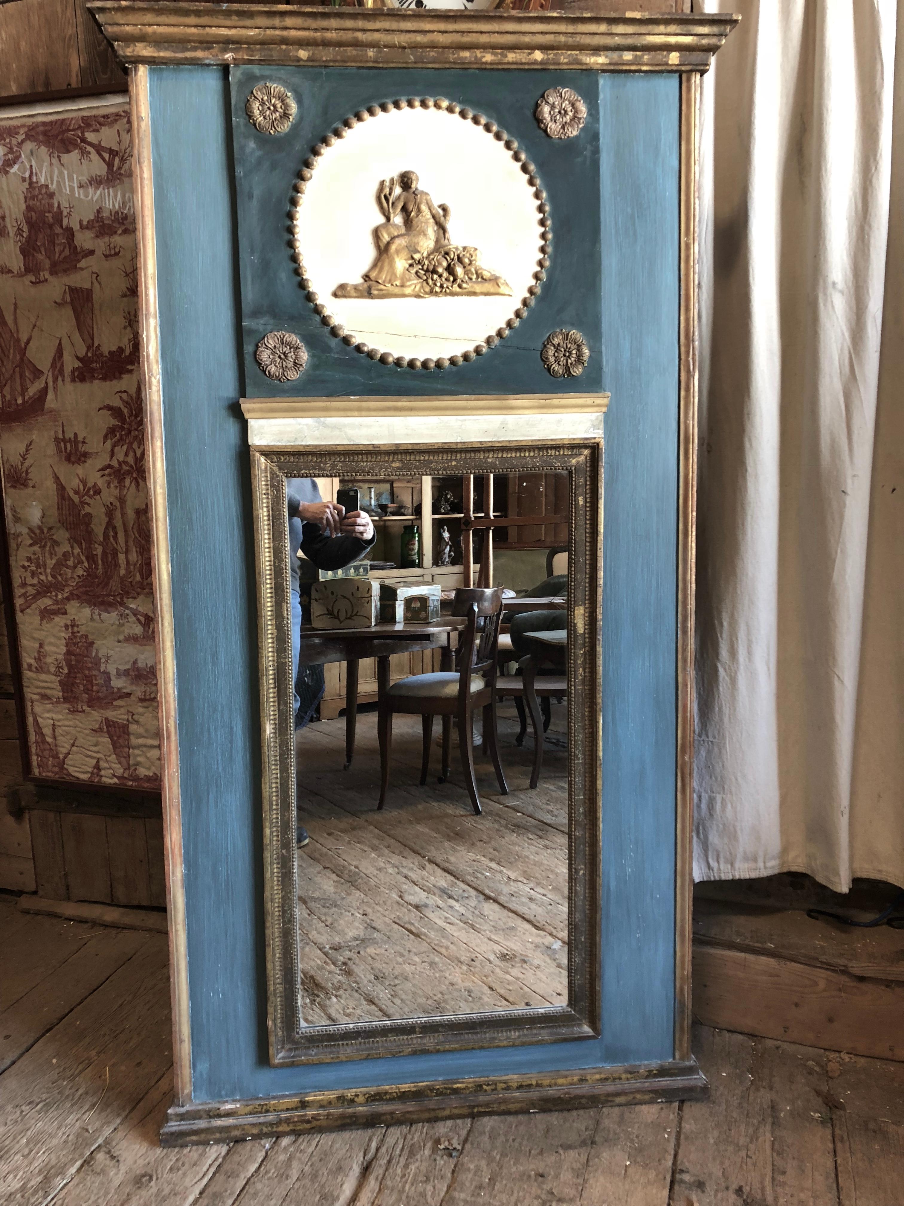 A neoclassical French trumeau mirror, circa 1780, in green, blue and cream painted finish with gilded decoration. Louis XVI period. Original glass plate.

  