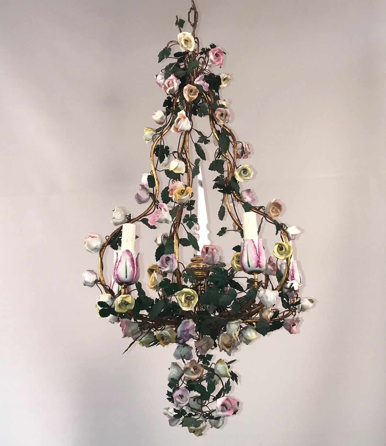 This Romantic chandelier is of a type made by the short-lived Vincennes factory absorbed by Sevres. It has a playful quality with stylized porcelain flowers and painted tole leaves. The candle cups are modelled as tulips.
The chandelier is centered