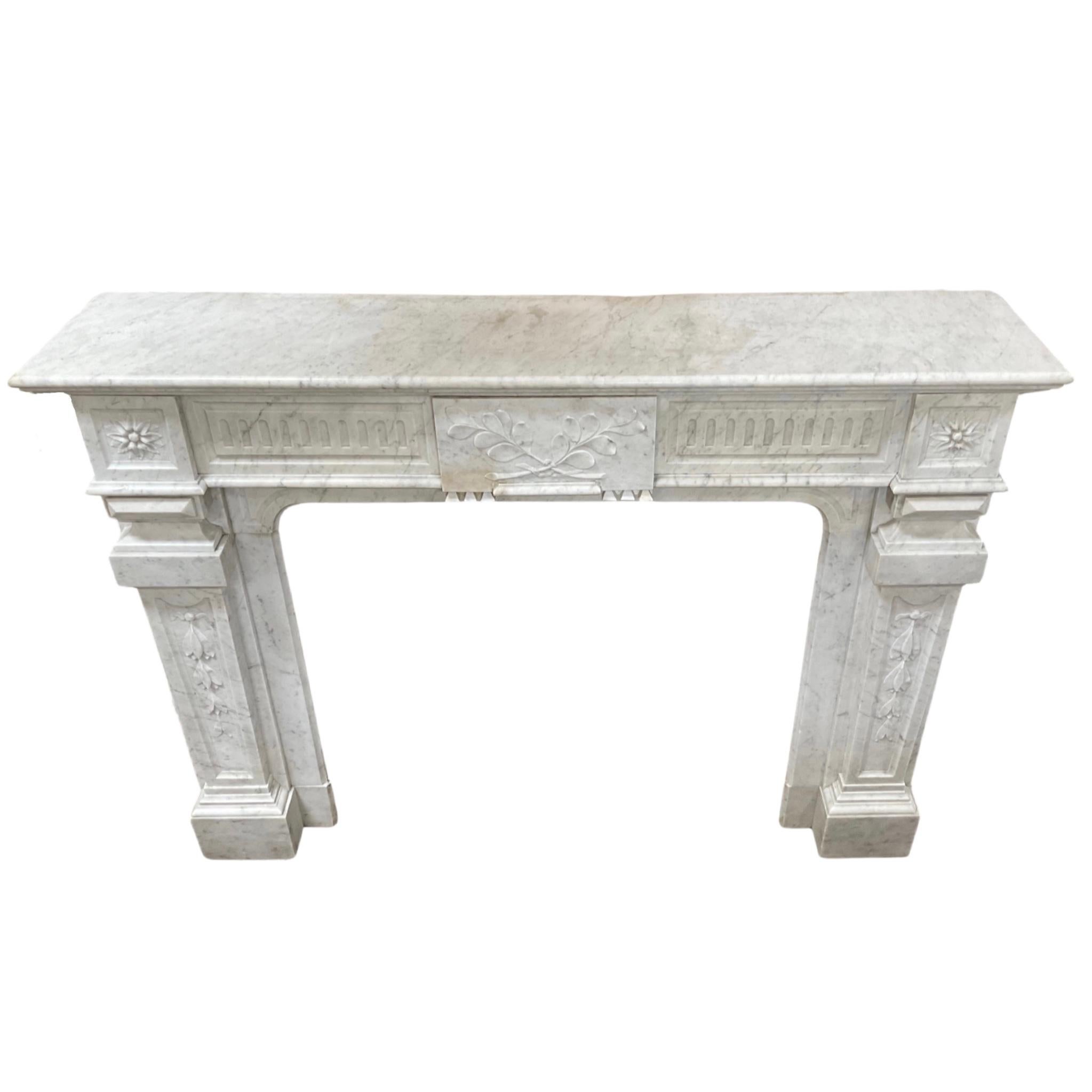 This antique Louis XVI style mantel, crafted in France during the 1880s, features a white marble construction for a classic and timeless look. Reinforcing this time-honored style, the mantel is sure to be an elegant accent to any room.
