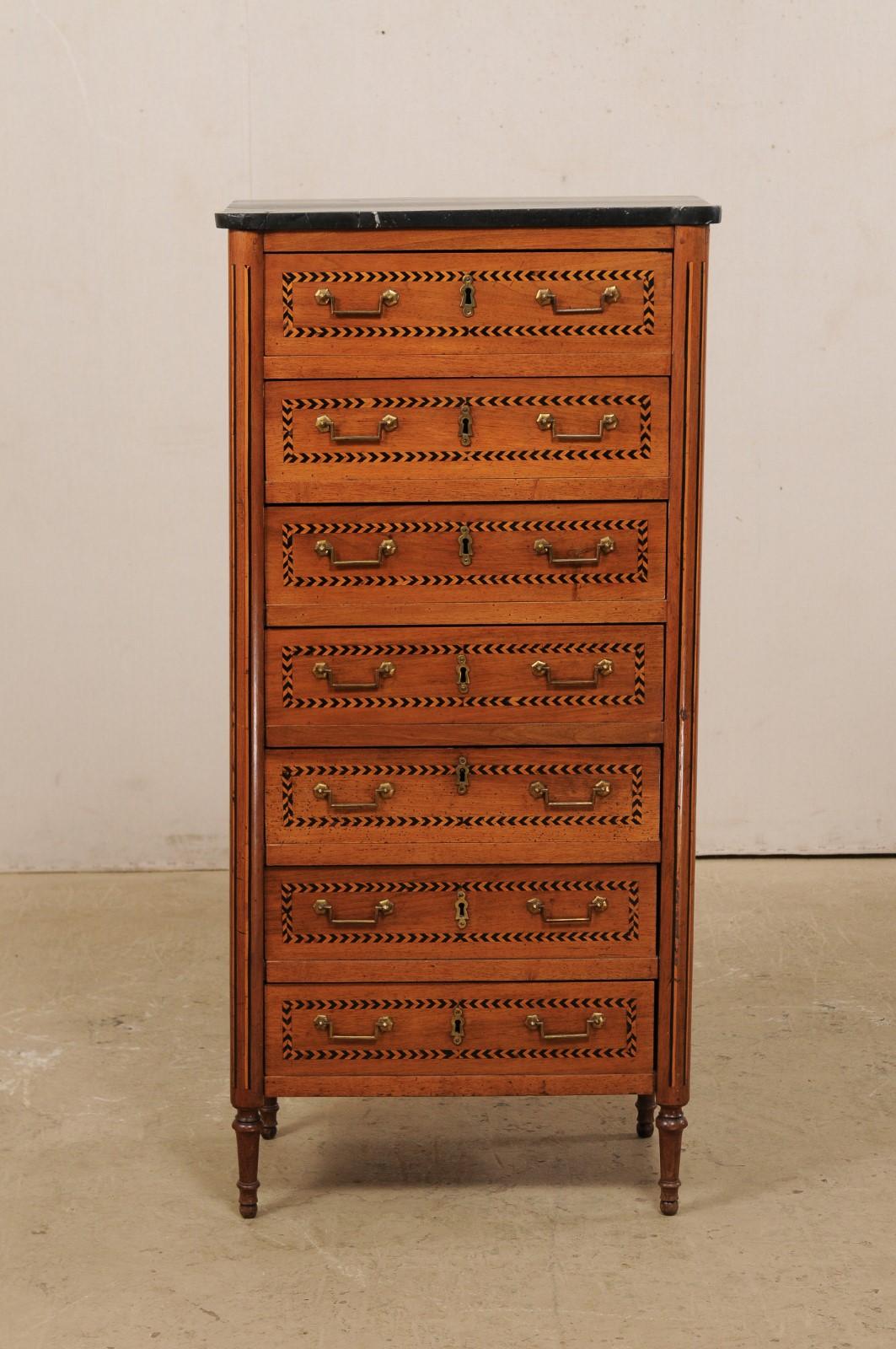 A French Louis XVI lingerie chest from the early 19th century. This antique chest from France features a semainier (or semaniere) design of seven drawers, typically used for storing lingerie or linens. This piece has been painted with a faux-marble