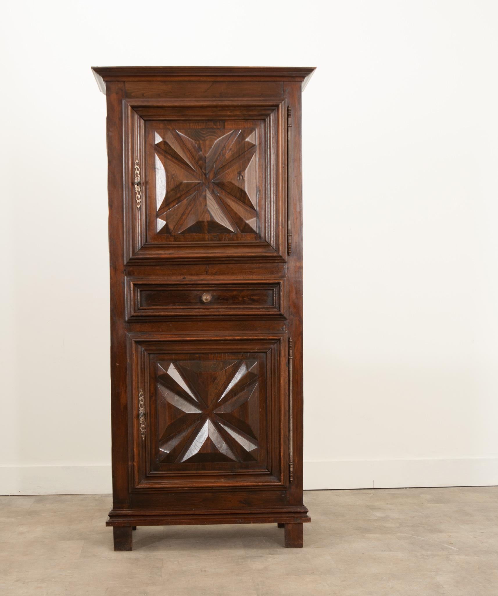 This stunning homme debout was hand carved in France during the 1800s and features sizable steel barrel hinges and hand cut escutcheons. Crafted from solid oak that’s gained a wonderful patina- the doors are thick with gem cut panels. Both doored