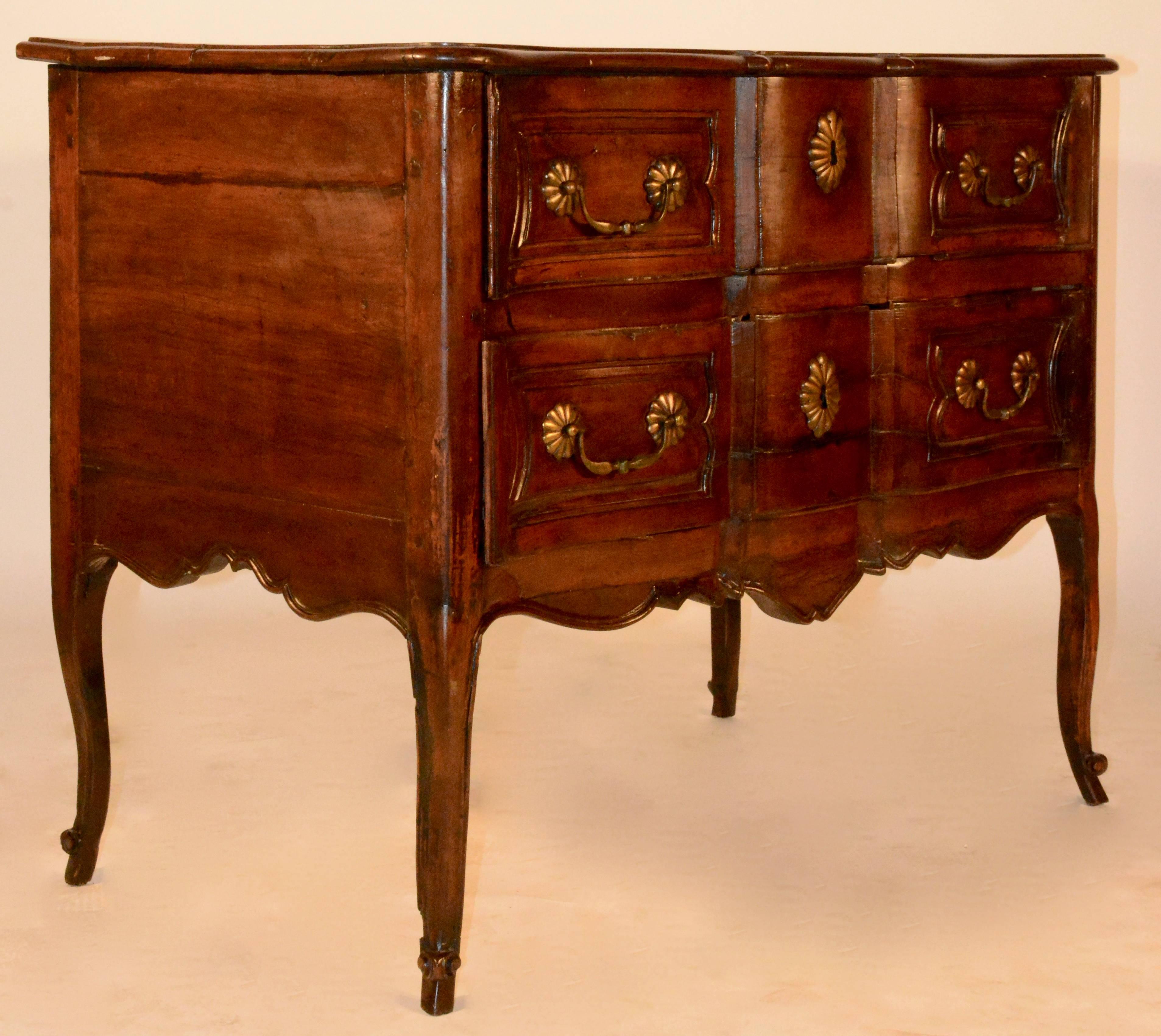 French Louise XV walnut serpentine front commode from the 18th century. This commode has heavy cast brass bail pulls and key escutcheons. Sits on beautiful cabriole legs with scrolled feet. Serpentine front that is beautifully handcrafted. All of