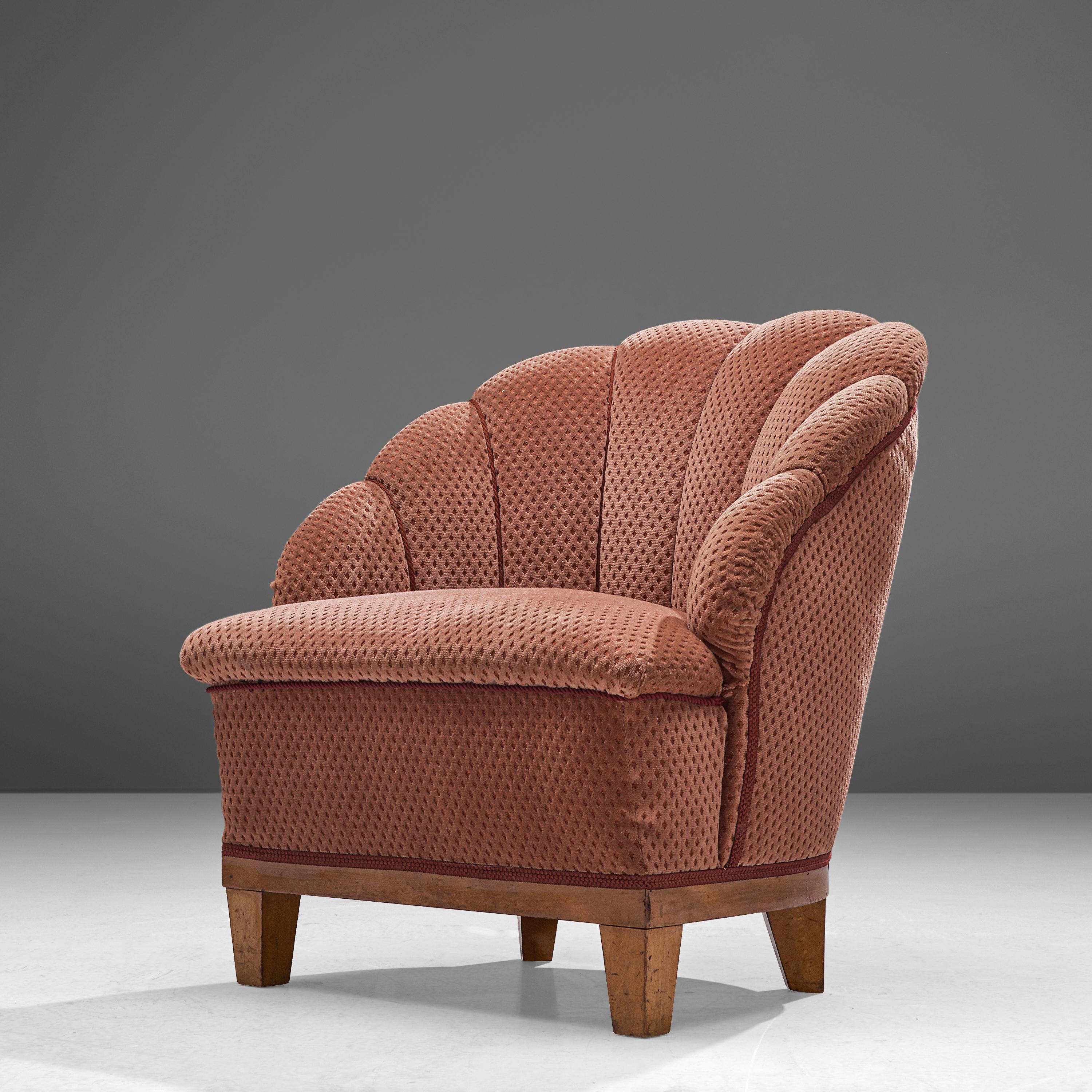 Lounge chair, fabric, oak, France, 1940s

Expressive French lounge chair with flowerlike shaped backrest. The round shape of this wonderful armchair features a vividly formed upholstery. Vertical lines structure the back- and armrest and end in a