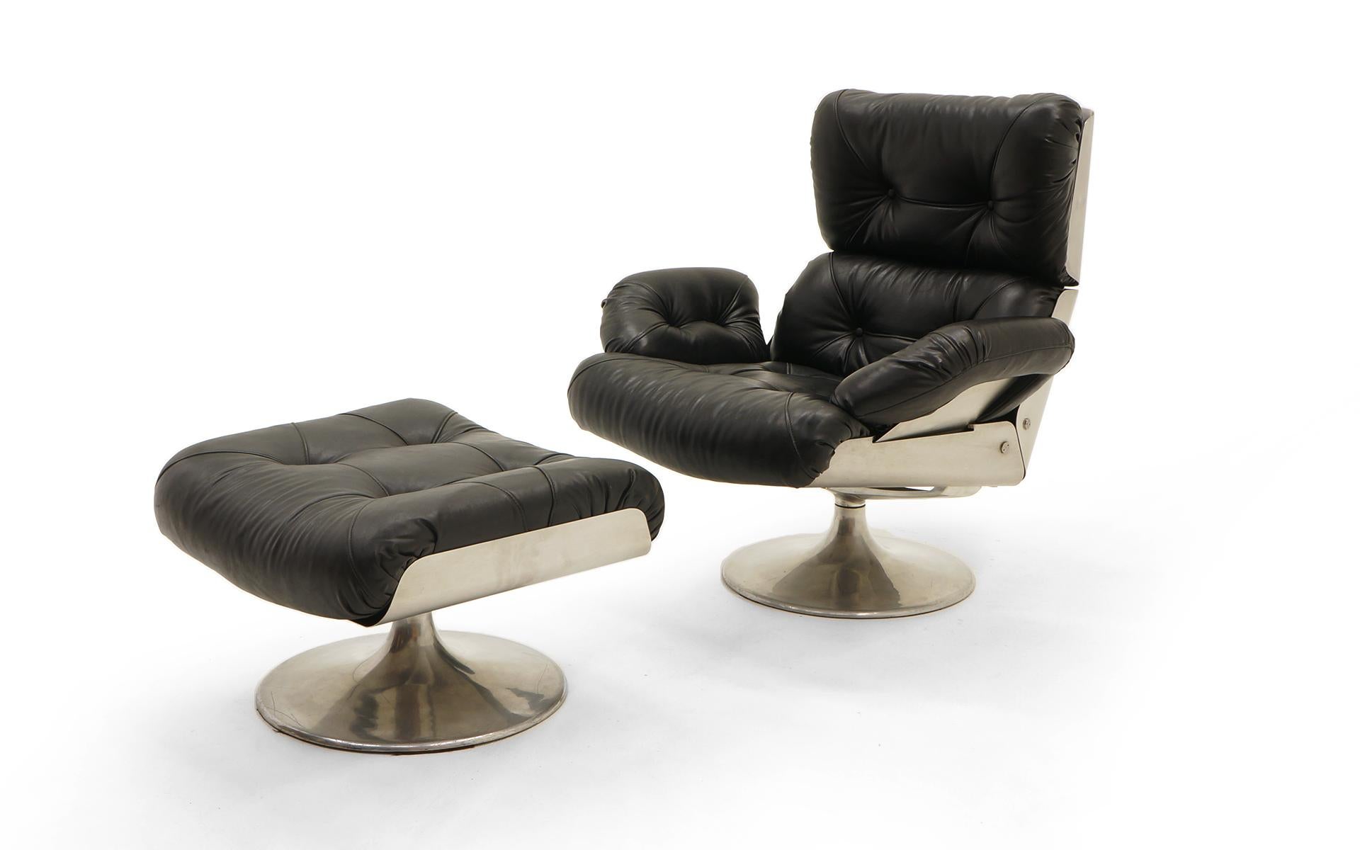 Rare and fine swivel lounge chair and swivel ottoman with cast aluminum and steel frame with original black vinyl upholstery, France, 1975. Tulip base to both pieces. A striking and comfortable design. What a great alternative to the near ubiquitous