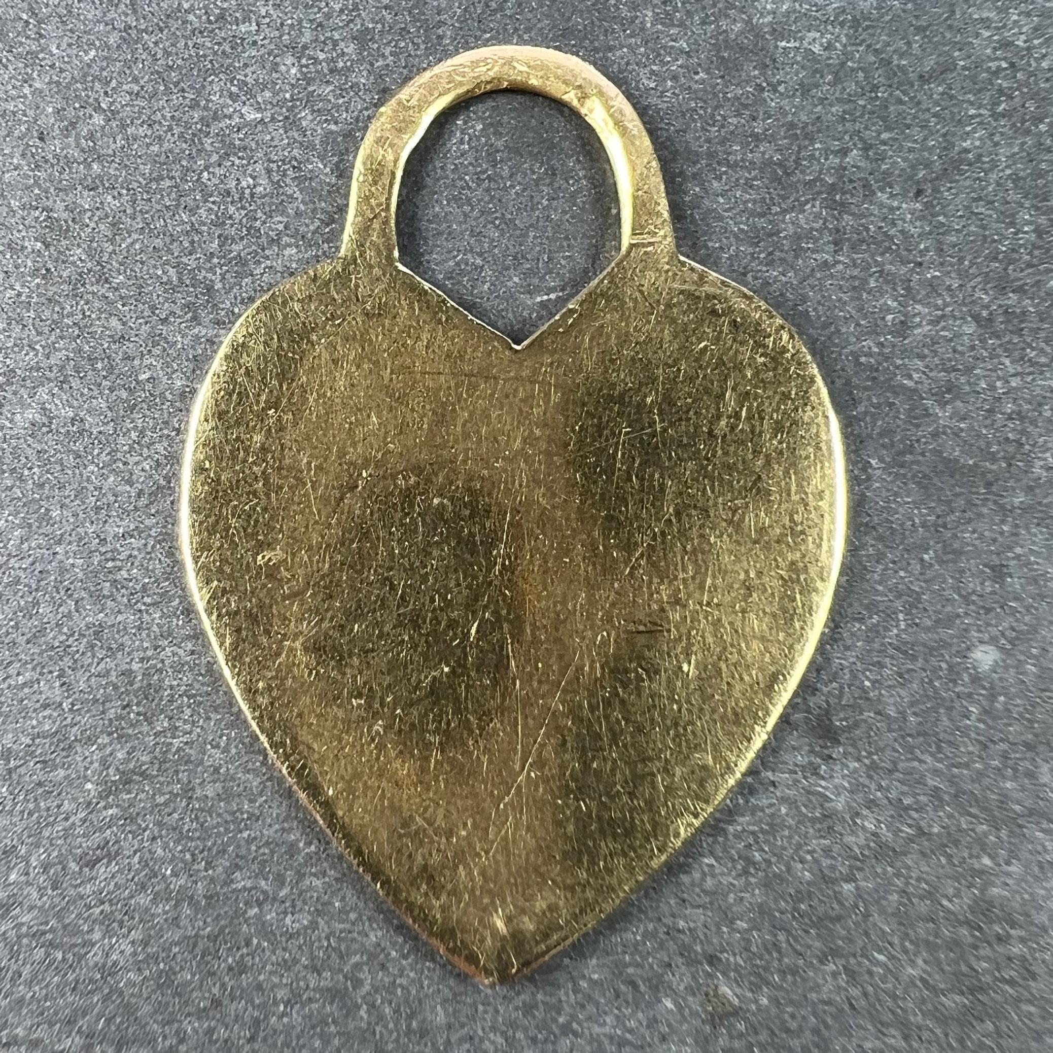 A French 18 karat (18K) yellow gold charm pendant designed as a love heart. Stamped with the eagle's head for French manufacture and 18 karat gold with an unknown maker's mark.

Dimensions: 2.8 x 2 x 0.1 cm (not including jump ring)
Weight: 3.20
