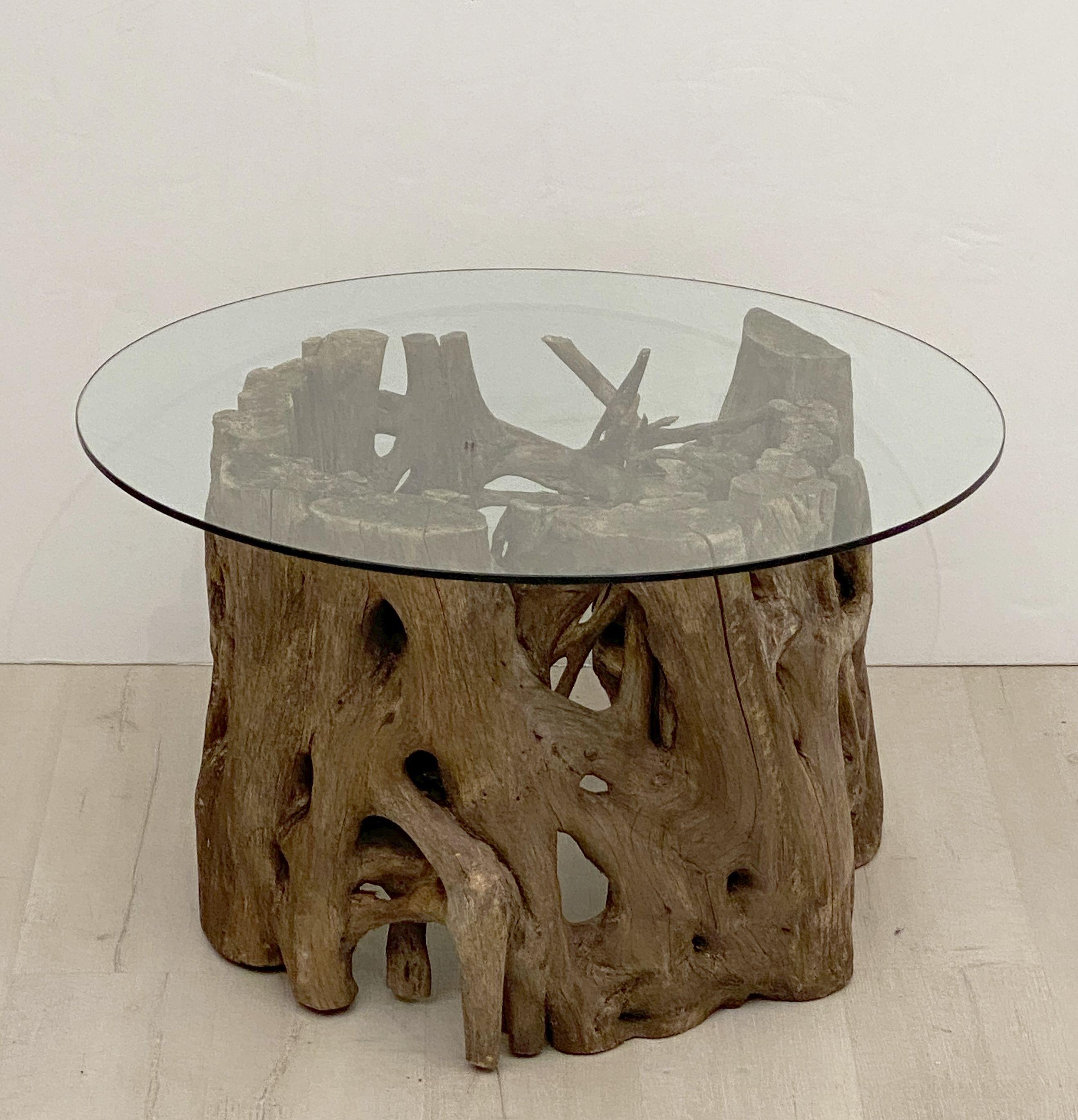 A fine French low table featuring a round or circular glass top set upon a rustic mangrove bog wood or driftwood base.

Perfect for use as a coffee or cocktail table.

Dimensions: Height 18 inches x Diameter 31 1/2 inches.