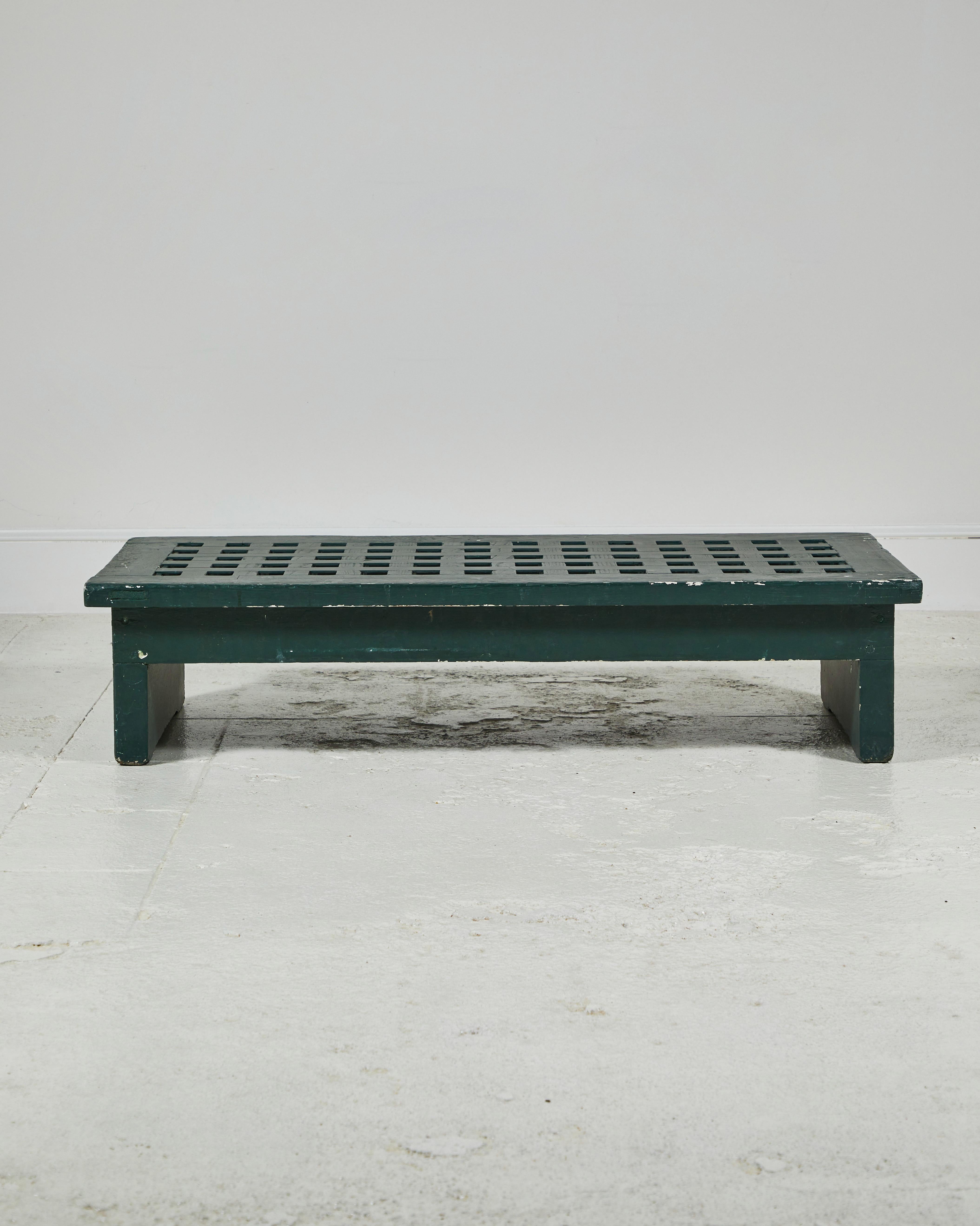 French low coffee table with perforated squares. The original paint is chipped and beautifully aged.