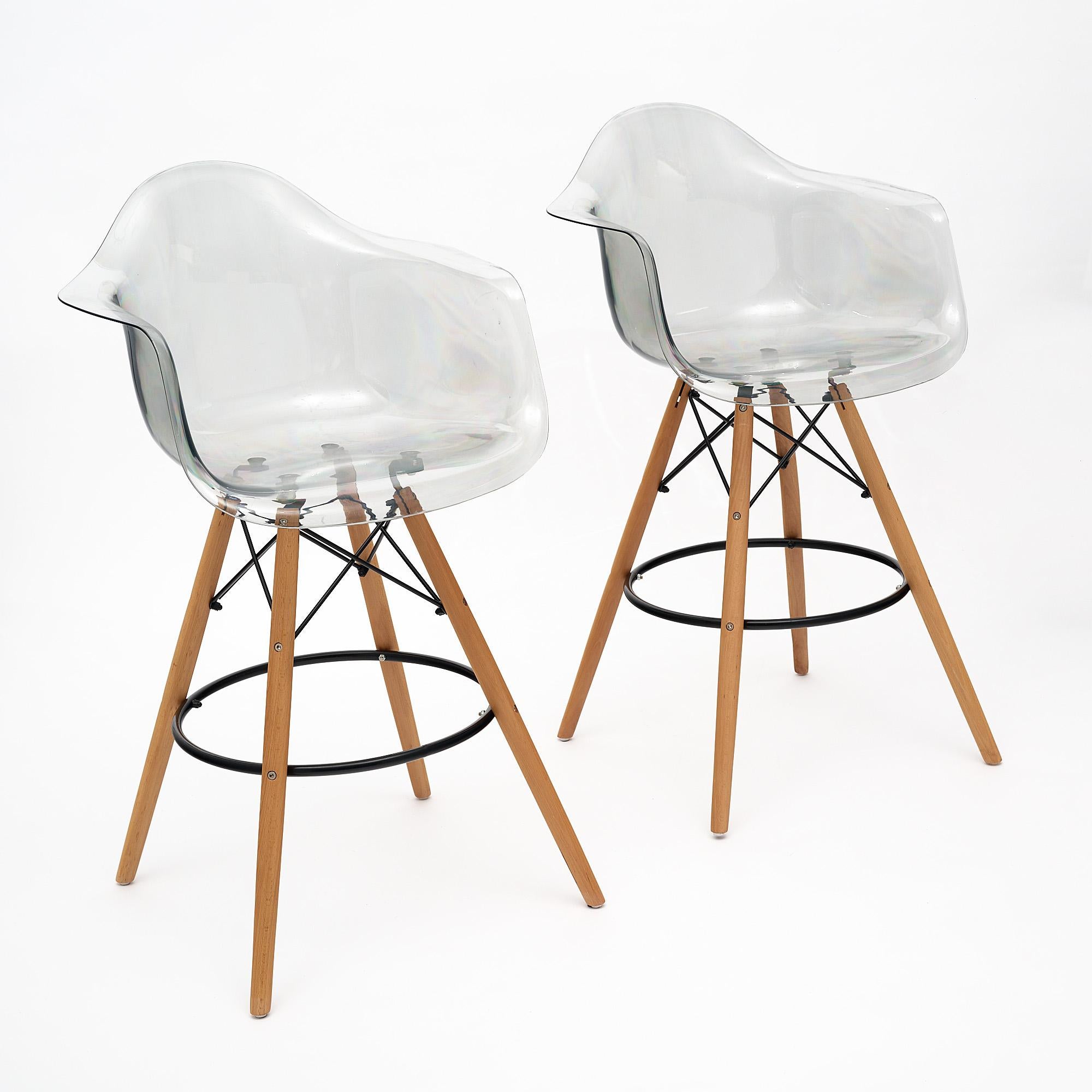 Pair of high chairs or bar stools made of Lucite with a wood and steel base.