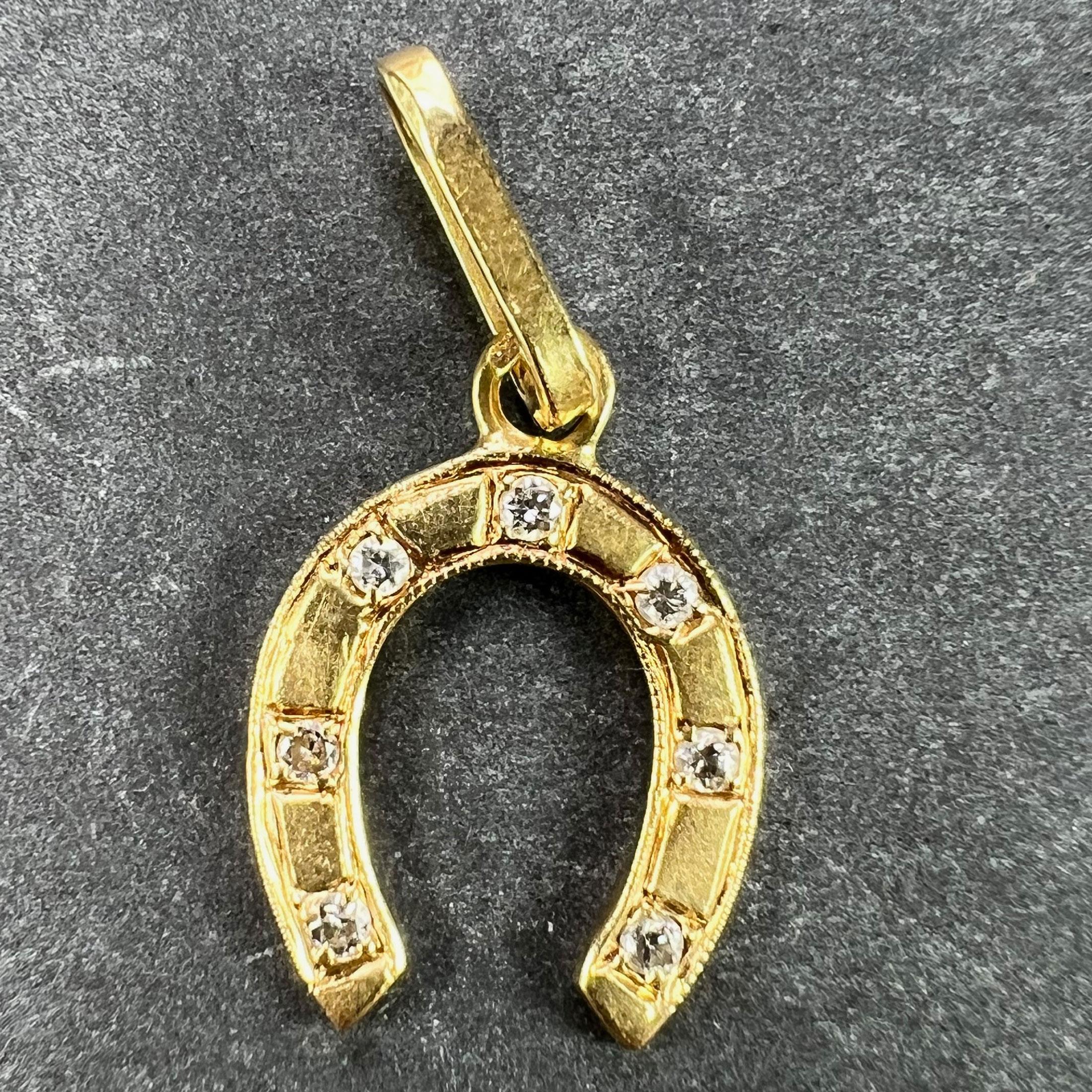 A French 18 karat (18K) yellow gold charm pendant designed as a lucky horseshoe set with seven diamonds. Stamped with the eagle's head for 18 karat gold and French manufacture.
 
Dimensions:1.5 x 1.1 x 0.11 cm (not including jump ring)
Weight: 0.88