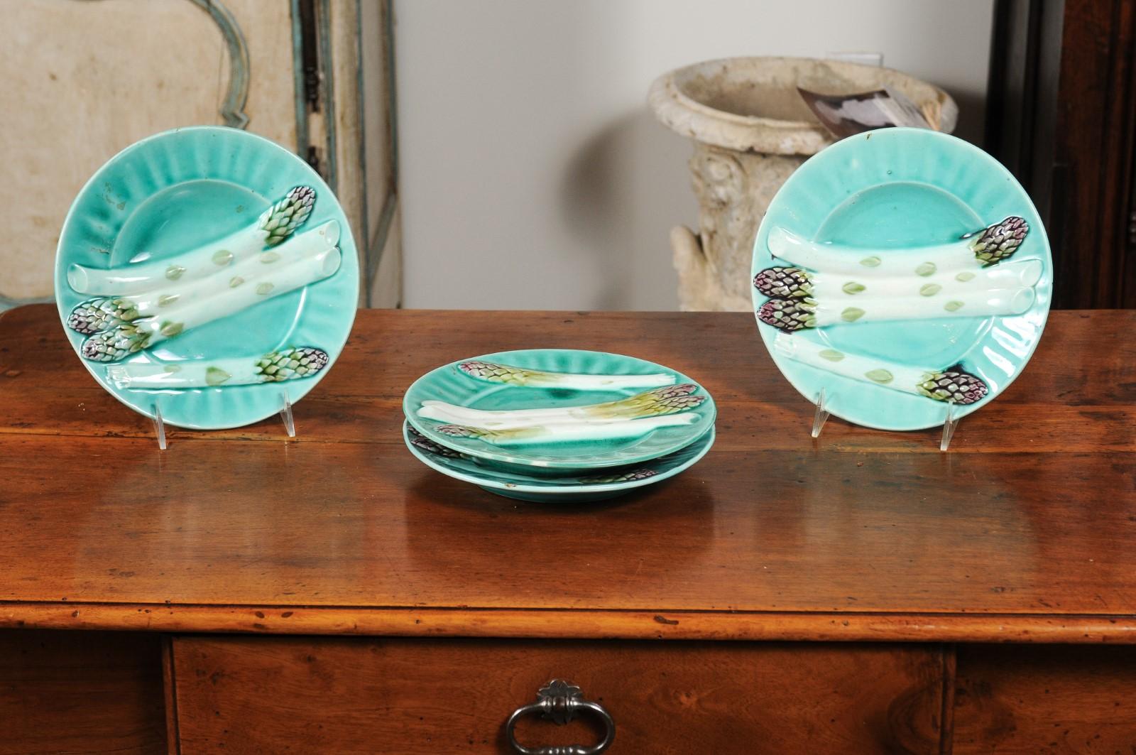 Four French 19th century turquoise barbotine asparagus plates from Lunéville, priced and sold individually. Born in the Lorraine area of France during the second half of the 19th century, each of these exquisite asparagus plates features a deep