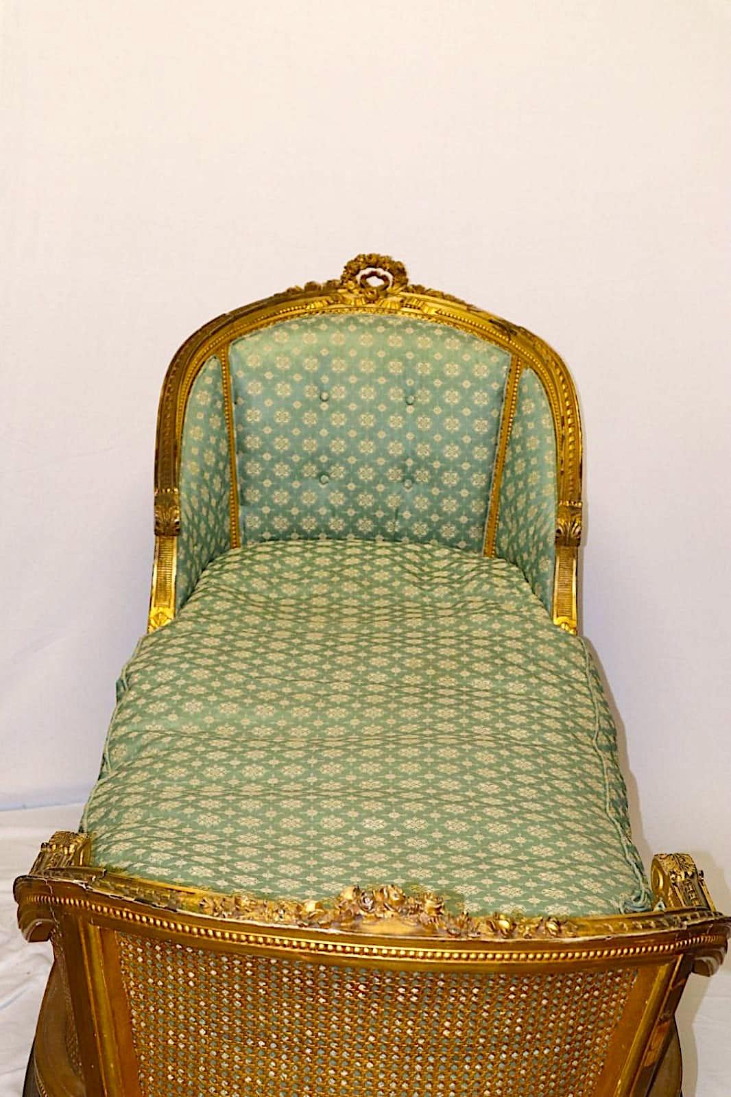 This French Louis XVI Recamier stretches nearly seven feet to woo the owner to relaxation. Heavily detailed carvings accentuated by giltwood which today is burnished along the sumptuous curves of the frame and gives a lasting warmth and beauty that