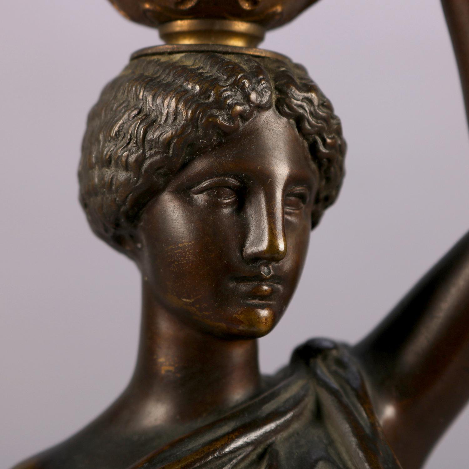 Antique French figural cast bronze portrait sculpture of Classical Greek Canephore (maiden, or woman, bearing a basket on her head in an early Greek religious festival) with pierced and gilt basket, seated on black marble base and signed Louis